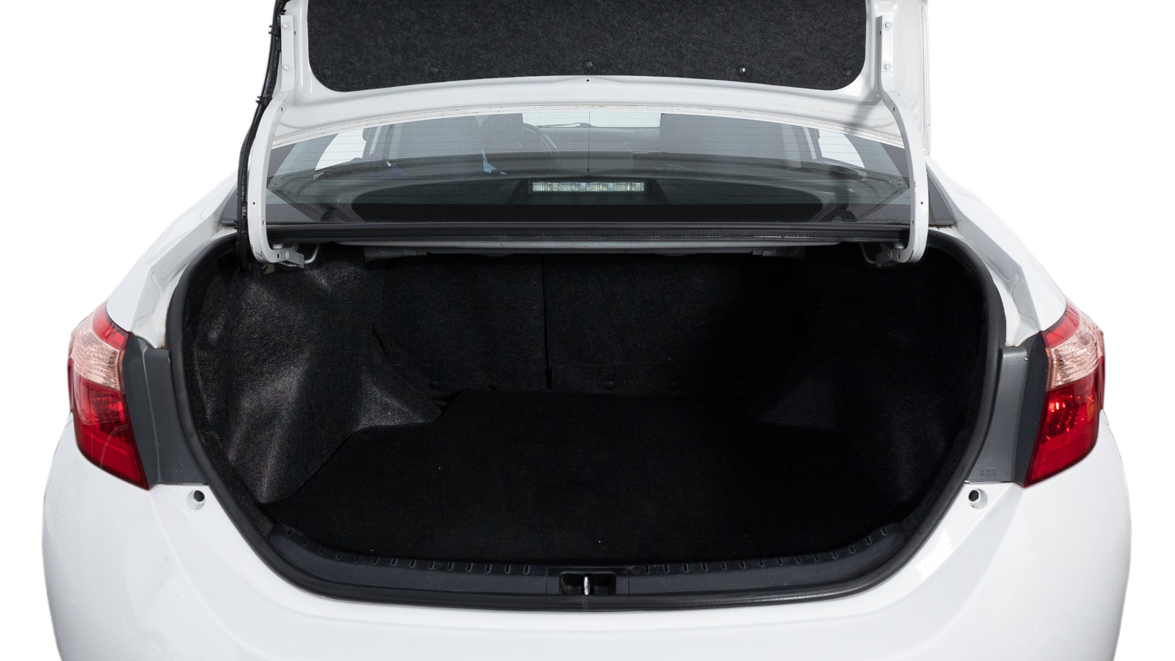The trunk lid is open, showing a full view of the trunk space. Two medium and two small suitcases are placed inside