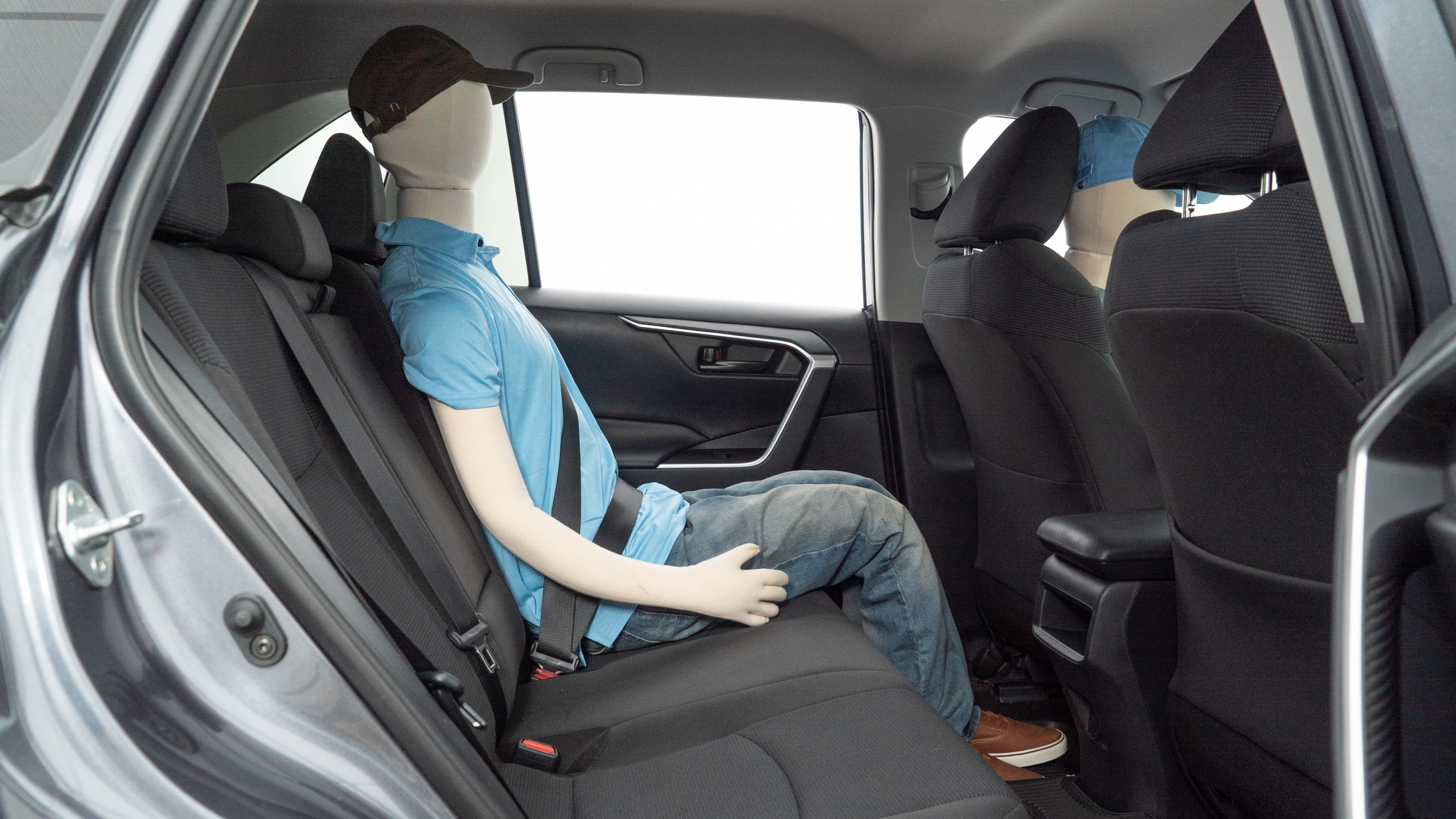 A series of second-row backseat photos is shown including one seating a baby seat and one seating a 6'1" mannequin.