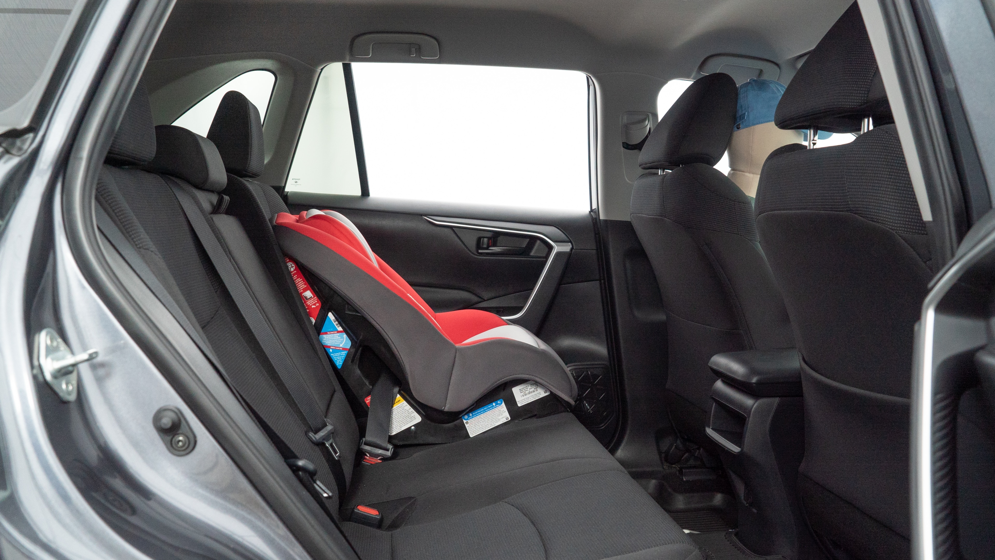 A series of second-row backseat photos is shown including one seating a baby seat and one seating a 6'1" mannequin.