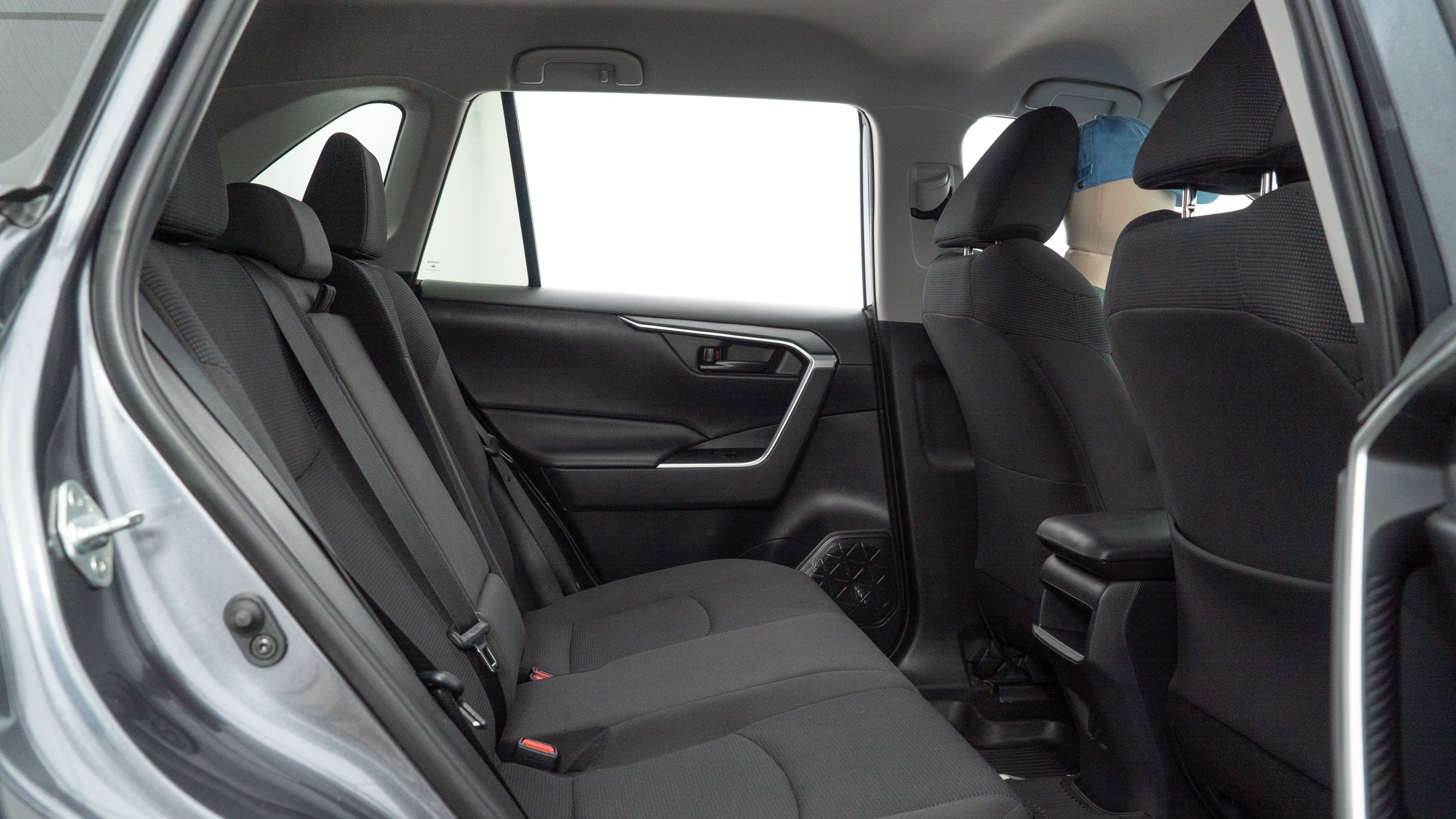 A series of second-row backseat photos is shown including one seating a baby seat and one seating a 6'1" mannequin.