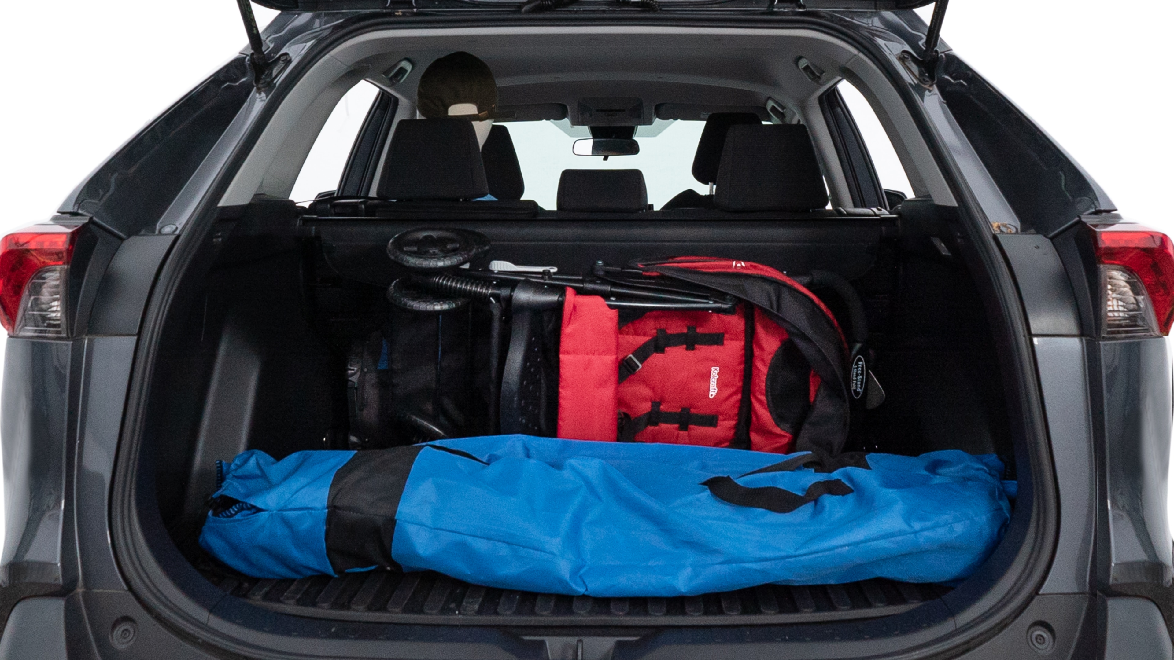 The trunk lid is open showing full view of the trunk. A baby stroller, three grocery carriers, two camping chairs in the carrying bag, and a set of golf clubs are placed inside.
