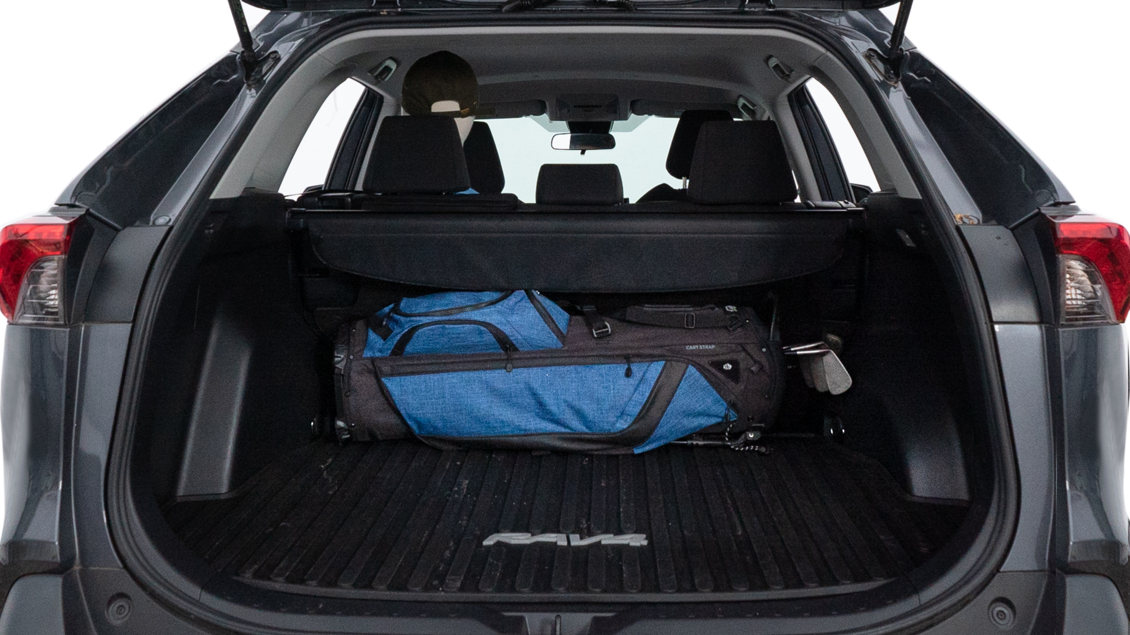 The trunk lid is open showing full view of the trunk. A baby stroller, three grocery carriers, two camping chairs in the carrying bag, and a set of golf clubs are placed inside.