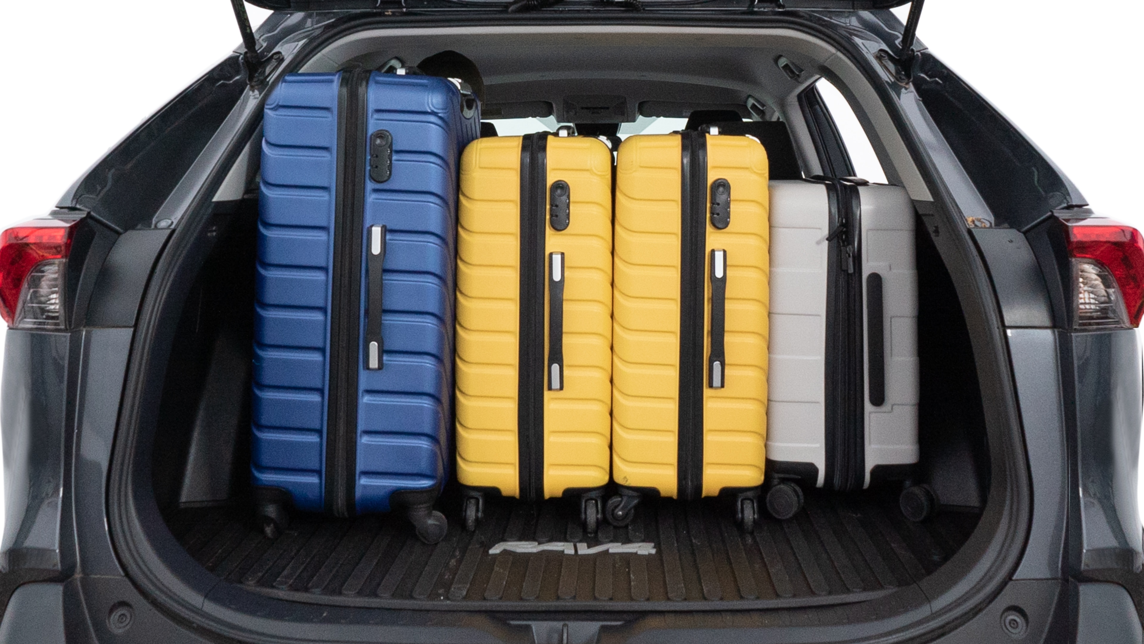 The trunk lid is open, showing full view of the trunk space. One large, two medium, and two small suitcases are placed inside.