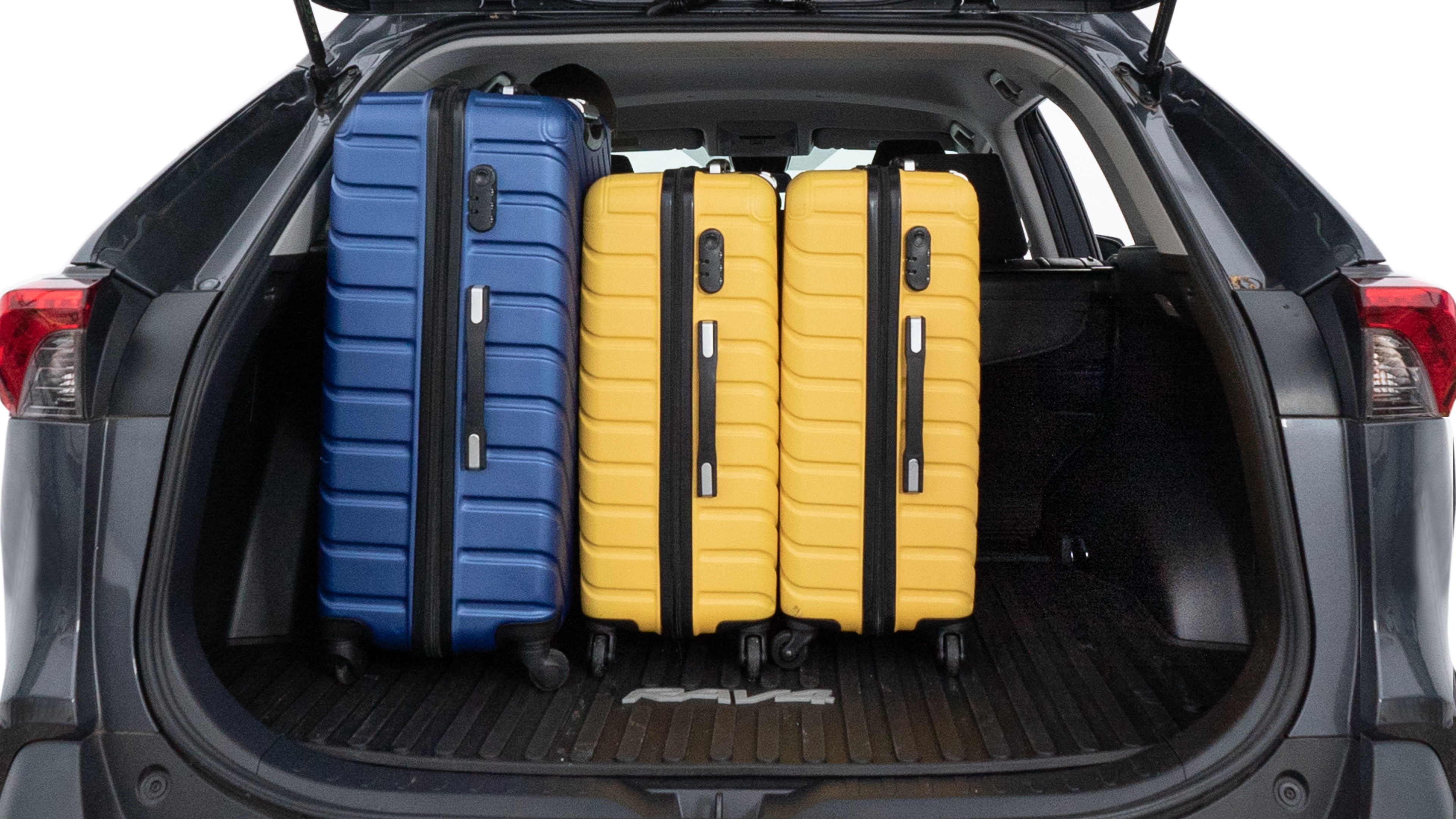 The trunk lid is open, showing full view of the trunk space. One large, two medium, and two small suitcases are placed inside.