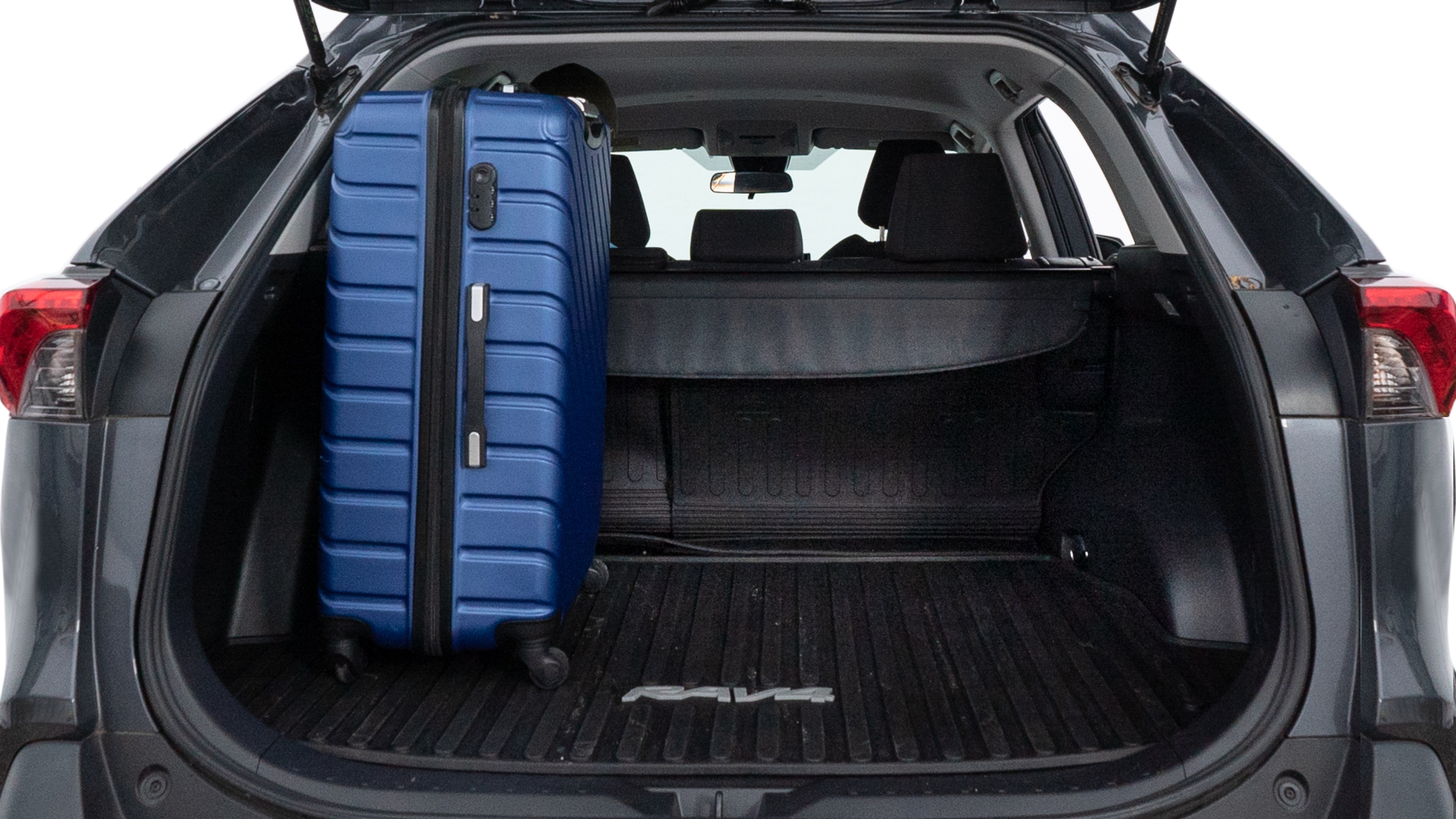 The trunk lid is open, showing full view of the trunk space. One large, two medium, and two small suitcases are placed inside.
