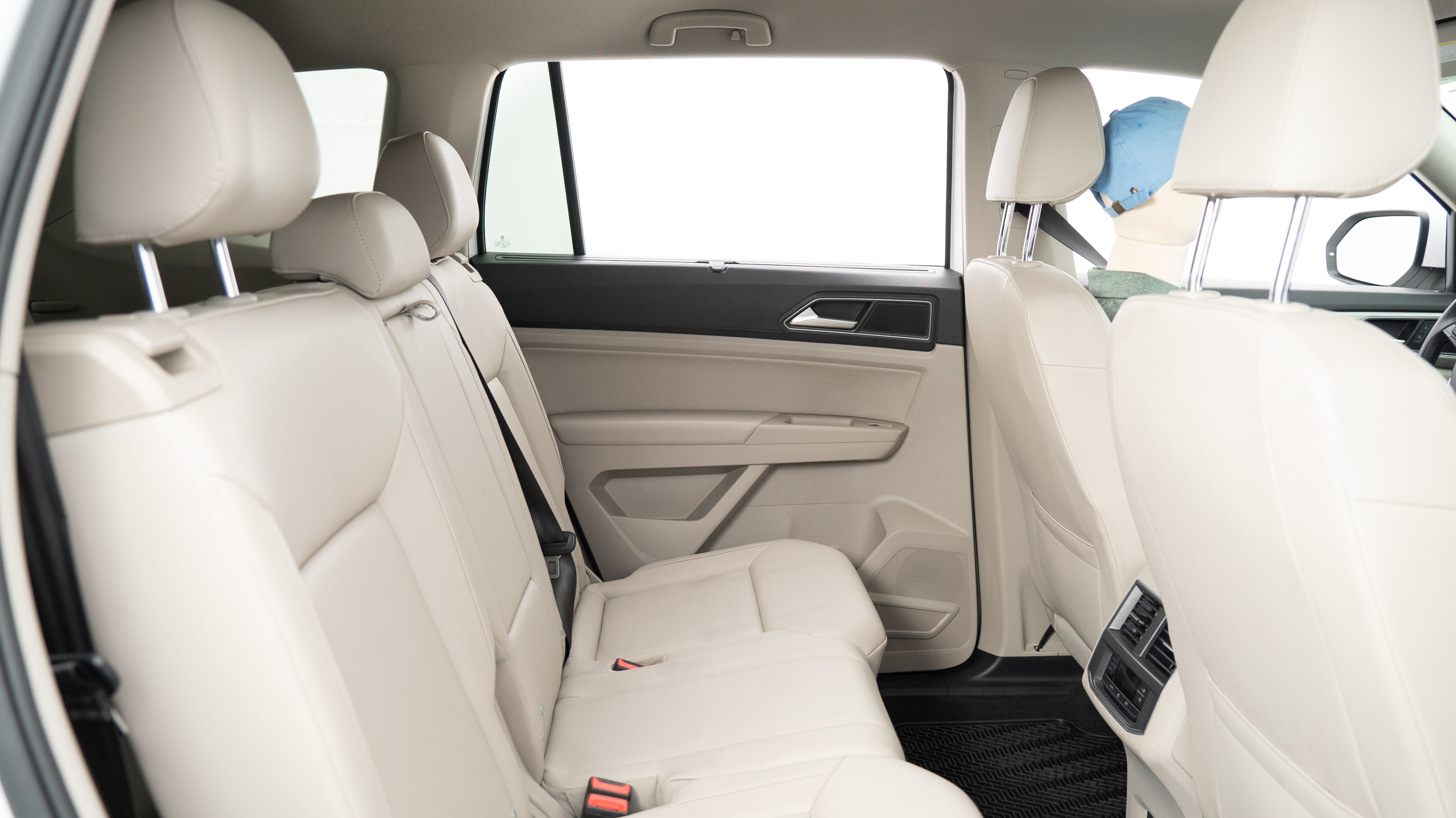 A series of second-row backseat photos is shown including one seating a baby seat, a dog and one seating a 6'1" mannequin.