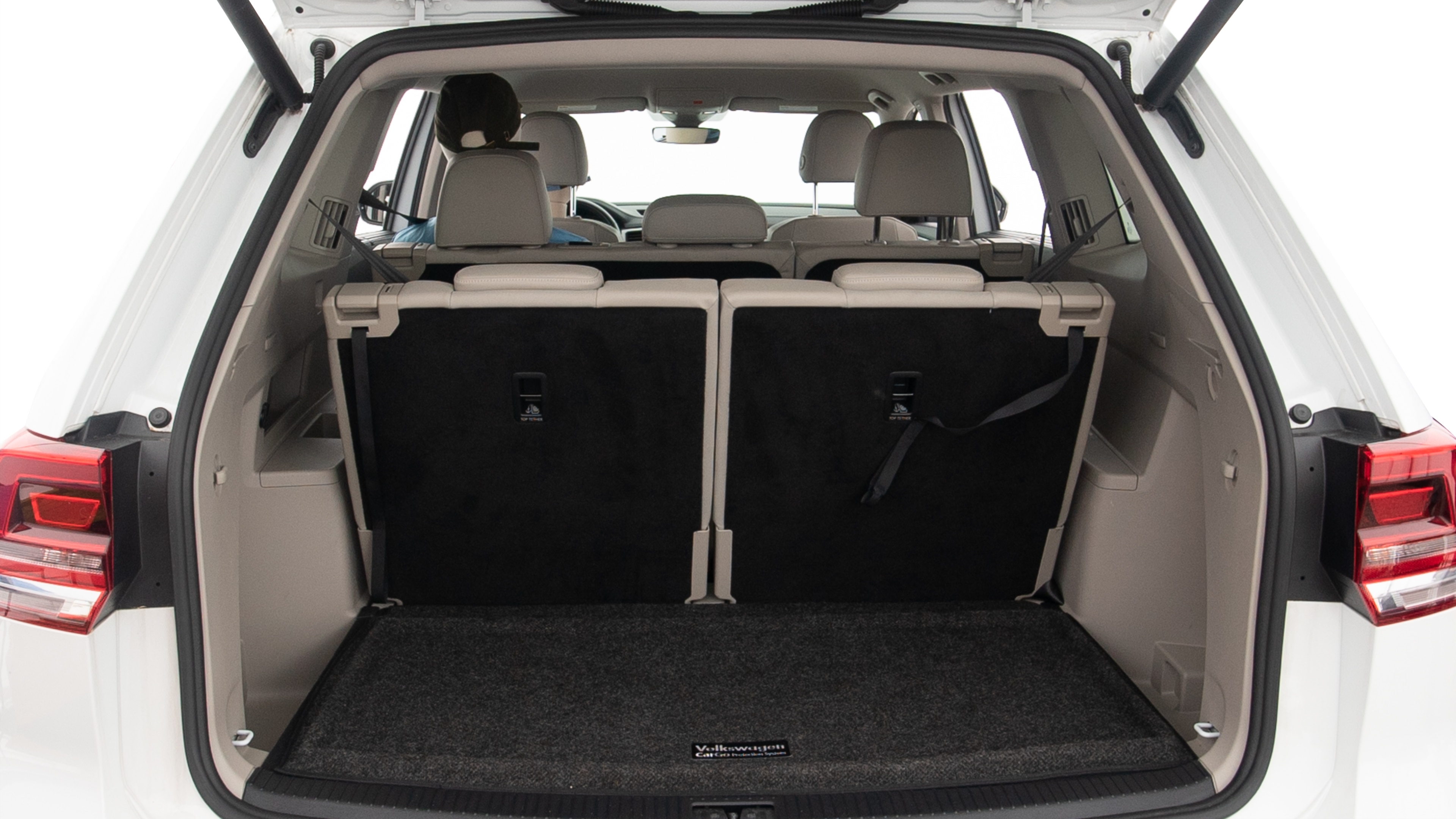 The trunk lid is open showing full view of the trunk. A baby stroller, three grocery carriers, two camping chairs in the carrying bag, and a set of golf clubs are placed inside.