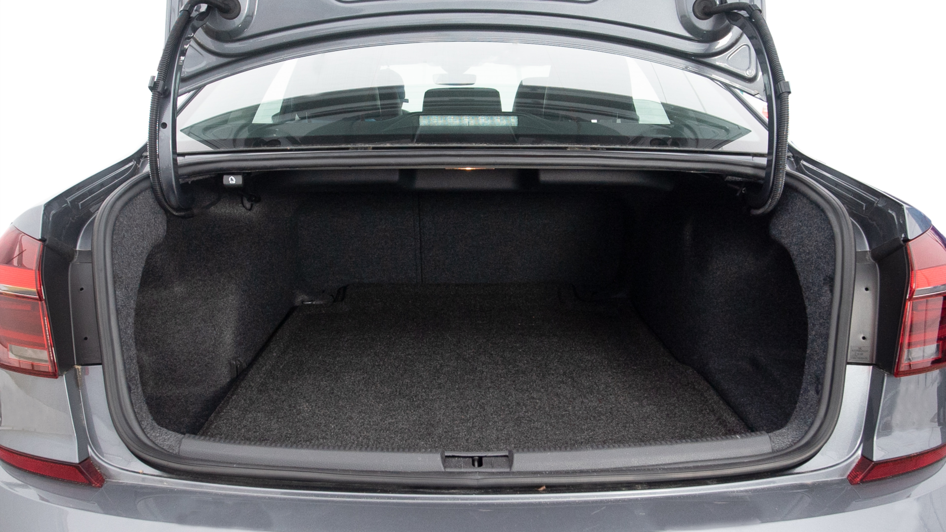 The trunk lid is open showing full view of the trunk. A baby stroller, three grocery carriers, two camping chairs in the carrying bag, and a set of golf clubs are placed inside.