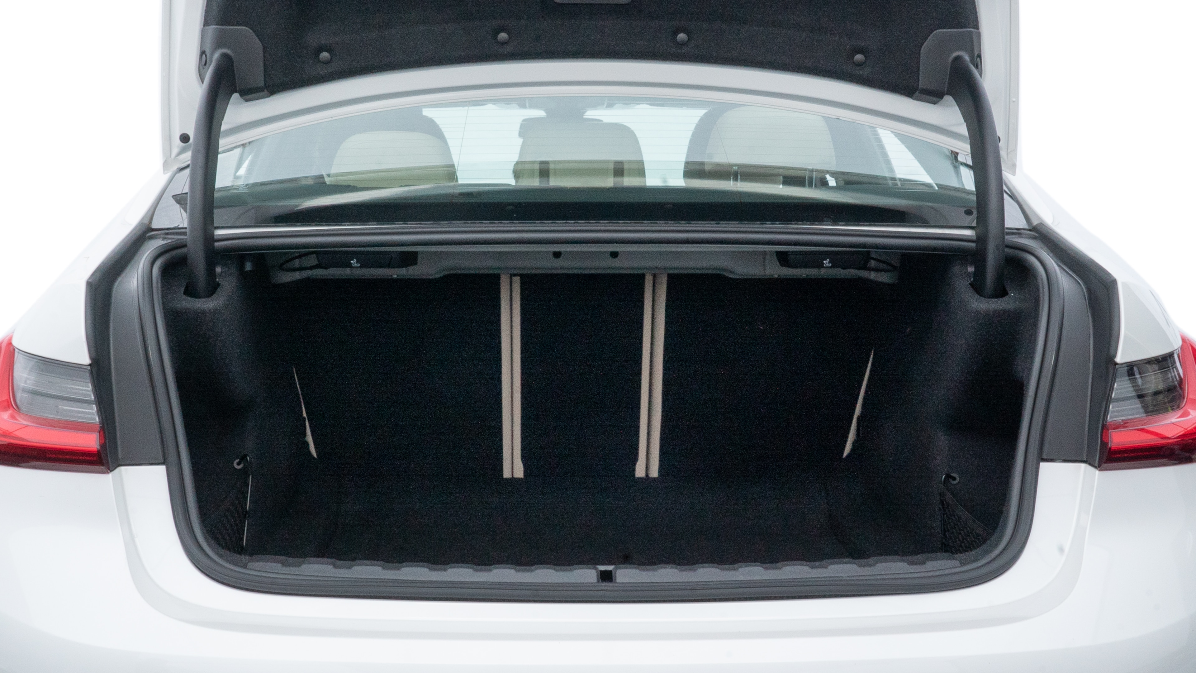 The trunk lid is open showing full view of the trunk. A baby stroller, three grocery carriers, two camping chairs in the carrying bag, and a set of golf clubs are placed inside.