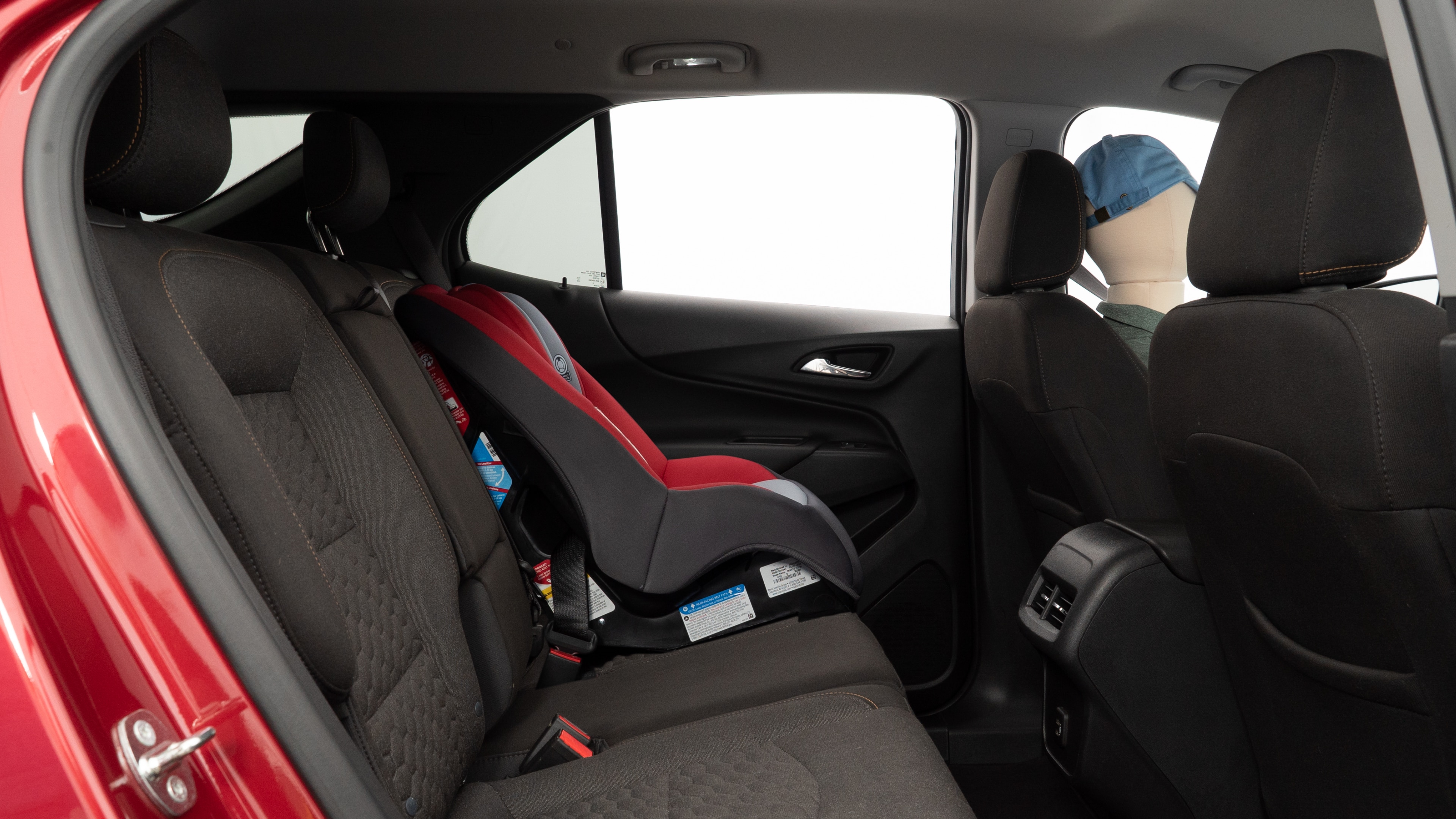 A series of second-row backseat photos is shown including one seating a baby seat and one seating a 6'1" mannequin.