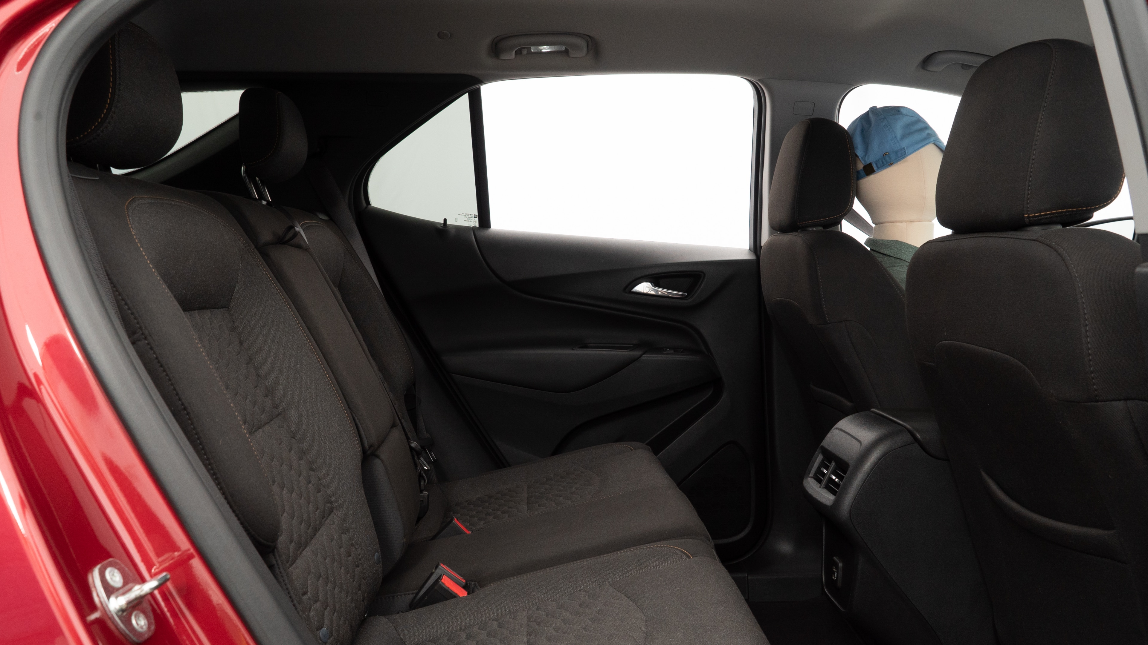 A series of second-row backseat photos is shown including one seating a baby seat and one seating a 6'1" mannequin.