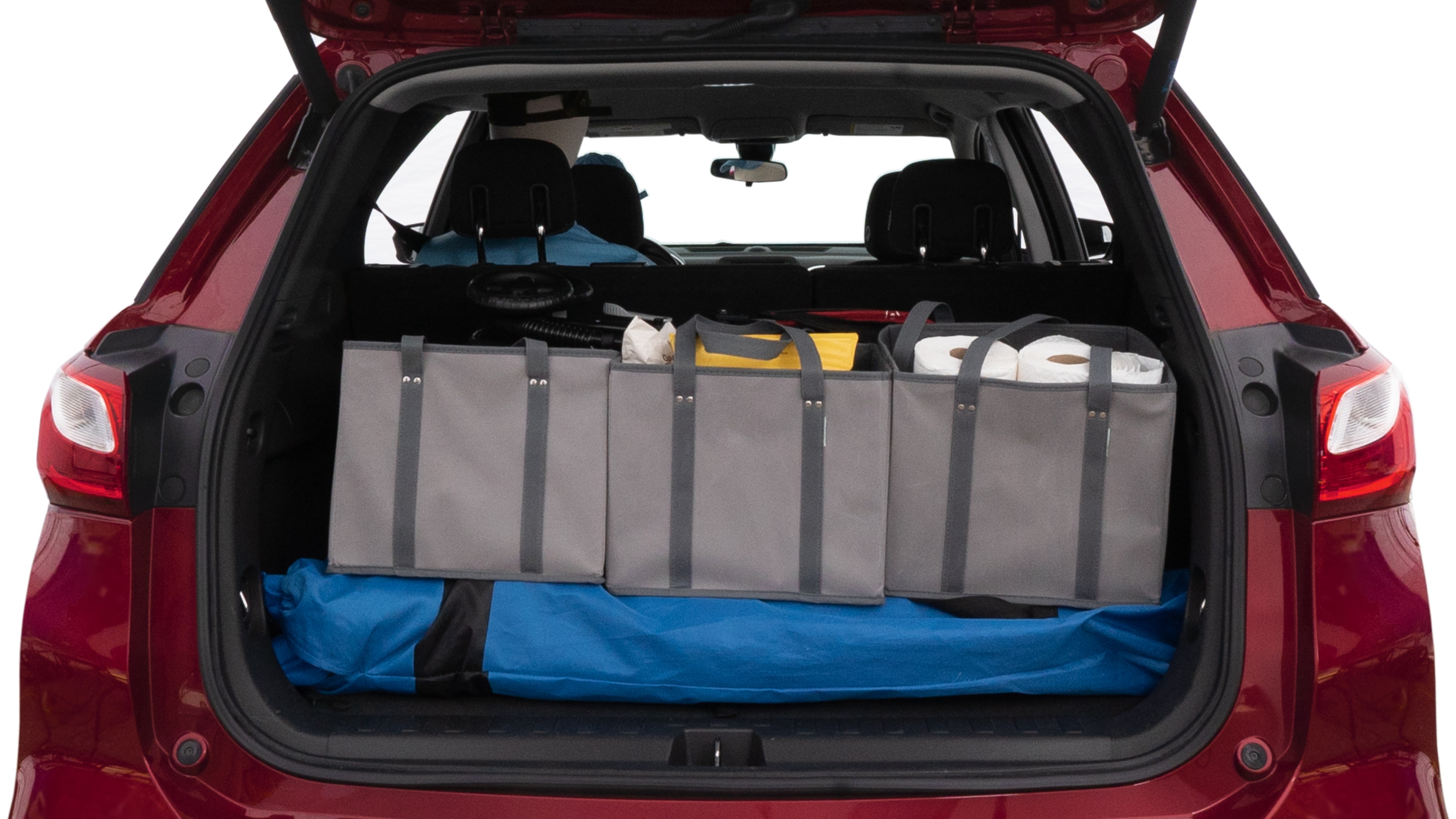 The trunk lid is open showing full view of the trunk. A baby stroller, three grocery carriers, two camping chairs in the carrying bag, and a set of golf clubs are placed inside.
