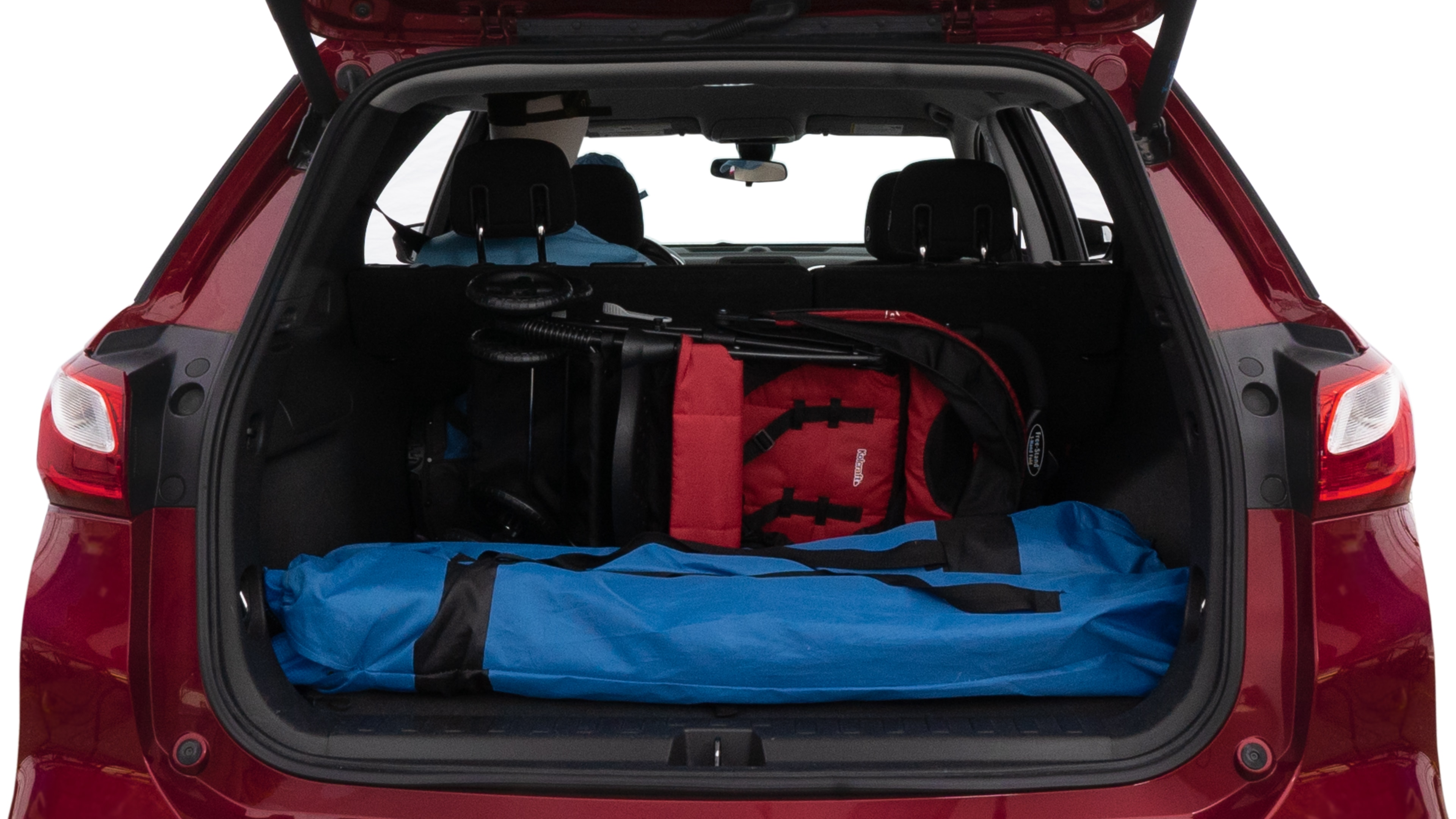The trunk lid is open showing full view of the trunk. A baby stroller, three grocery carriers, two camping chairs in the carrying bag, and a set of golf clubs are placed inside.