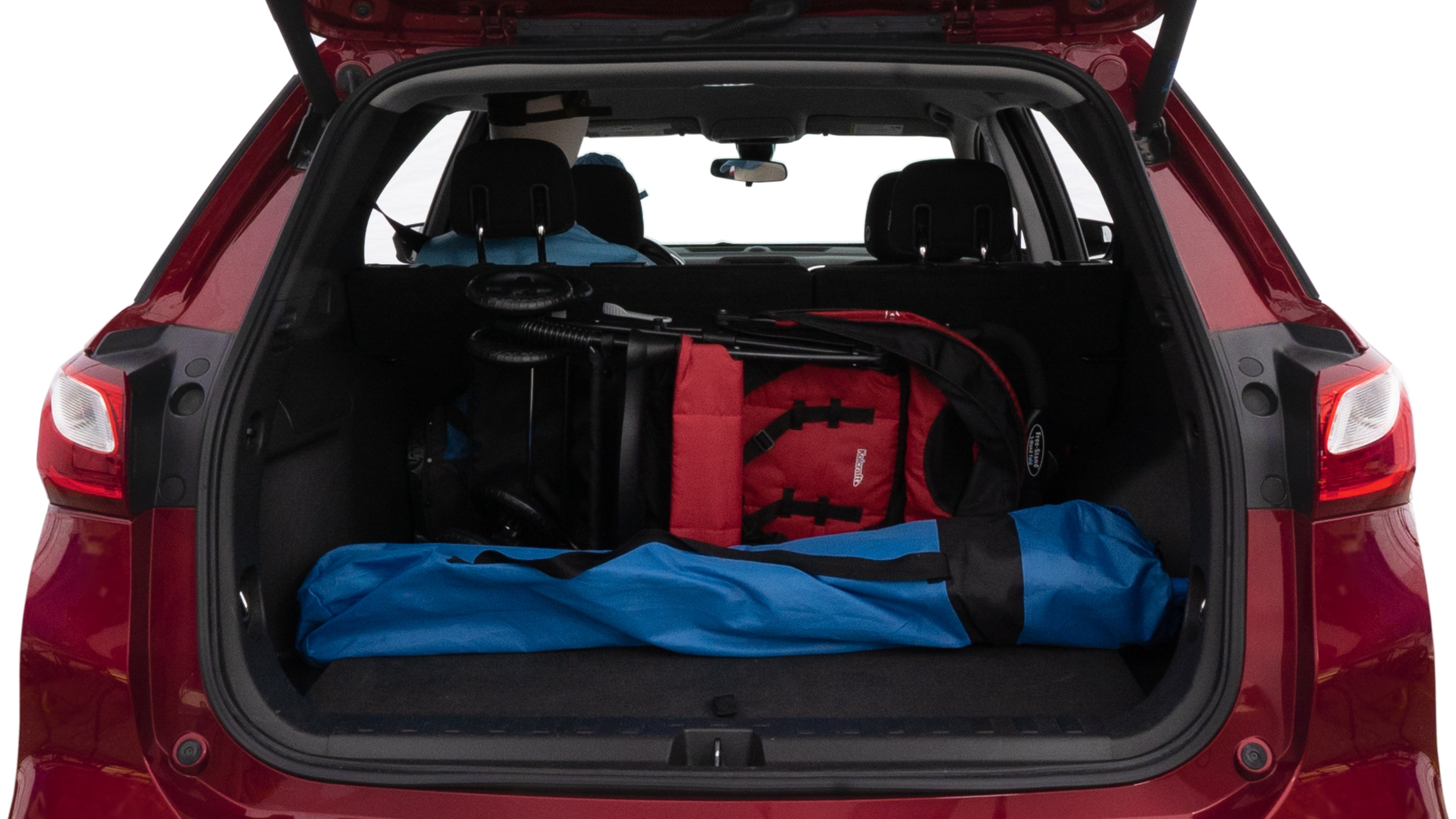 The trunk lid is open showing full view of the trunk. A baby stroller, three grocery carriers, two camping chairs in the carrying bag, and a set of golf clubs are placed inside.