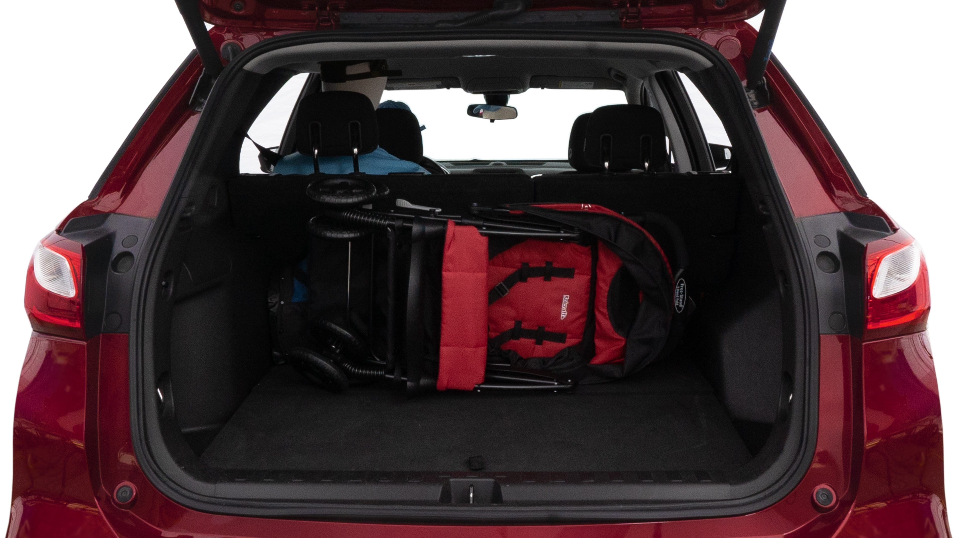 The trunk lid is open showing full view of the trunk. A baby stroller, three grocery carriers, two camping chairs in the carrying bag, and a set of golf clubs are placed inside.