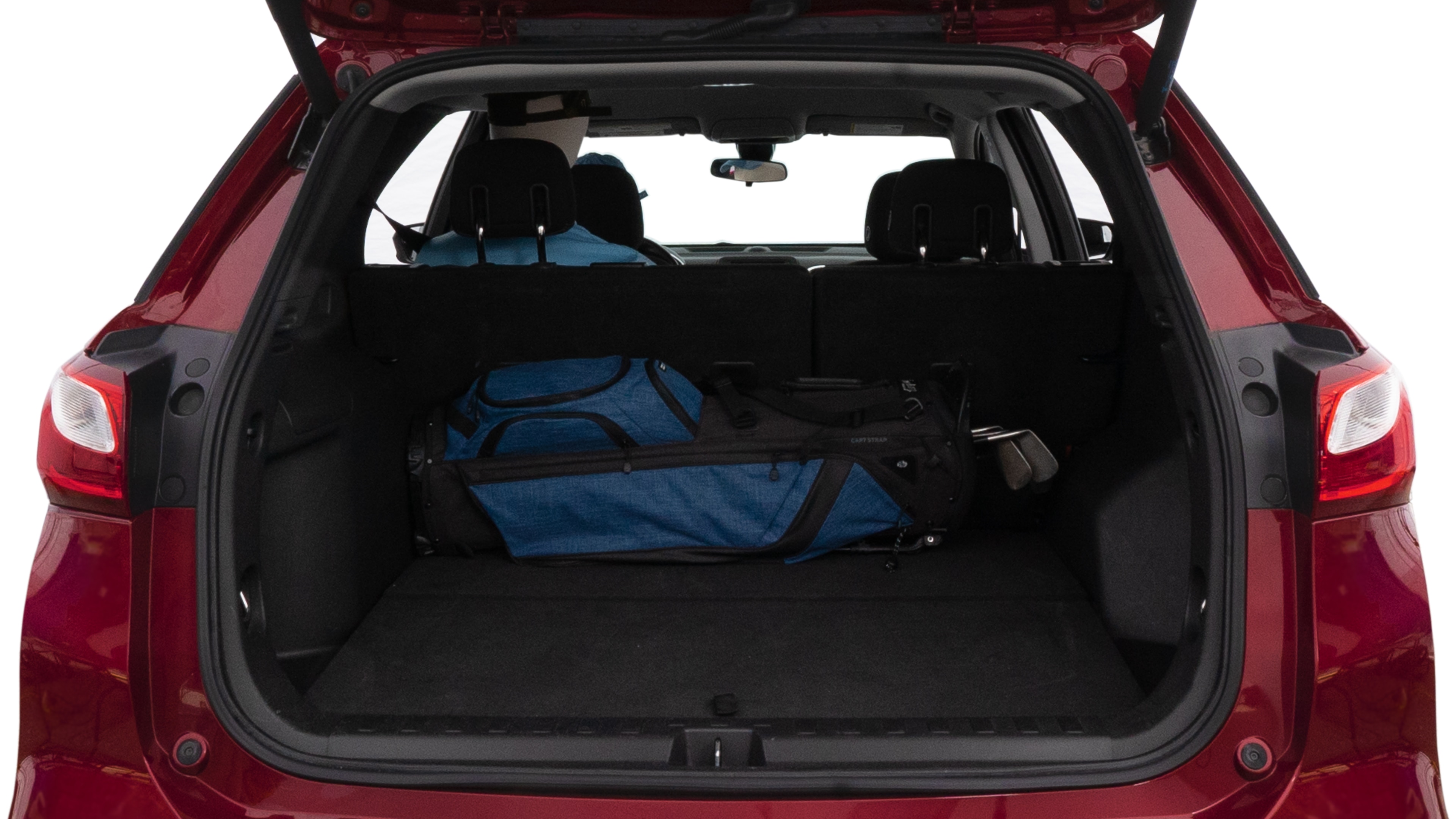 The trunk lid is open showing full view of the trunk. A baby stroller, three grocery carriers, two camping chairs in the carrying bag, and a set of golf clubs are placed inside.