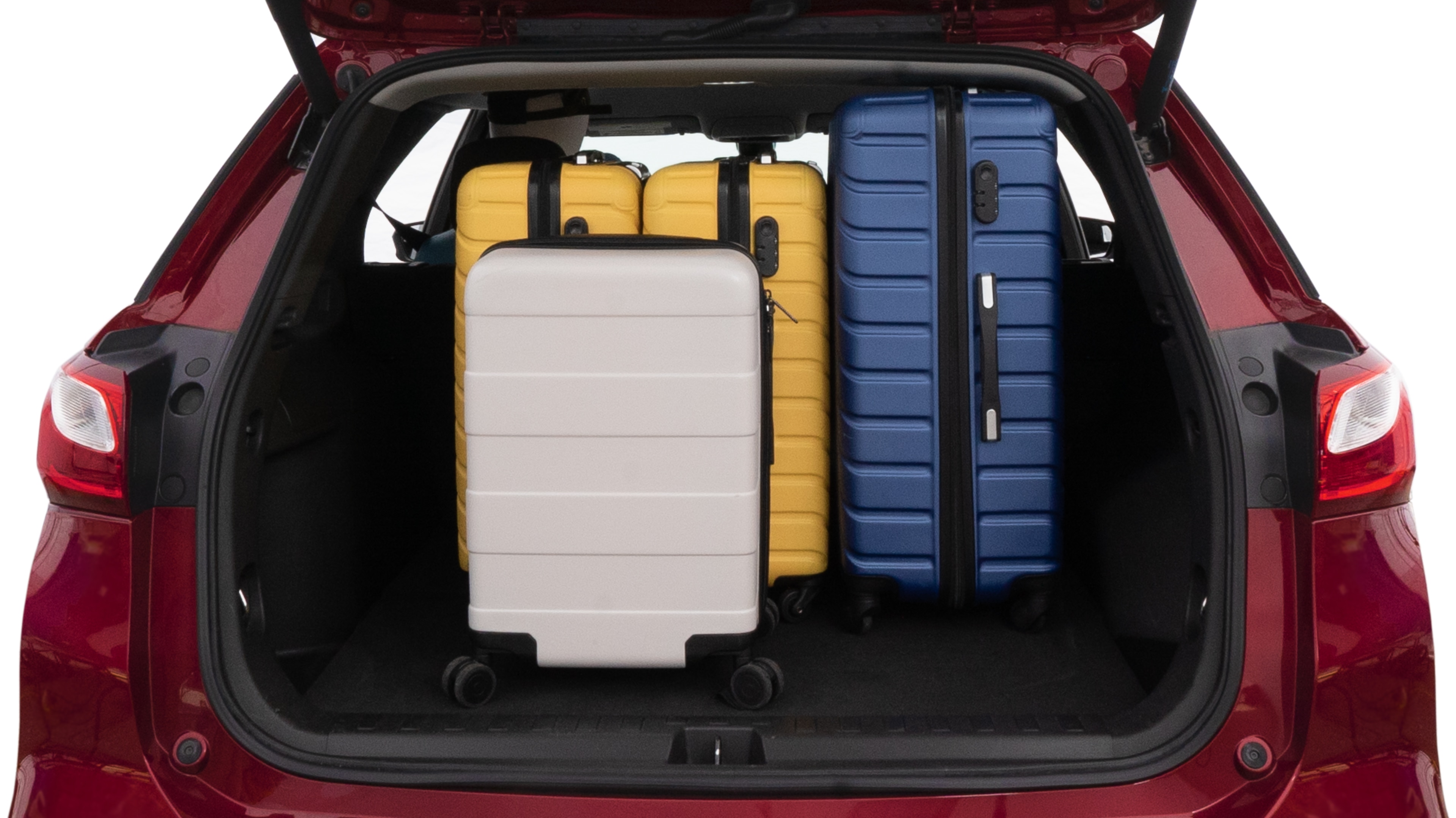 The trunk lid is open, showing full view of the trunk space. One large suitcase, two medium suitcases and one small suitcase are placed inside.
