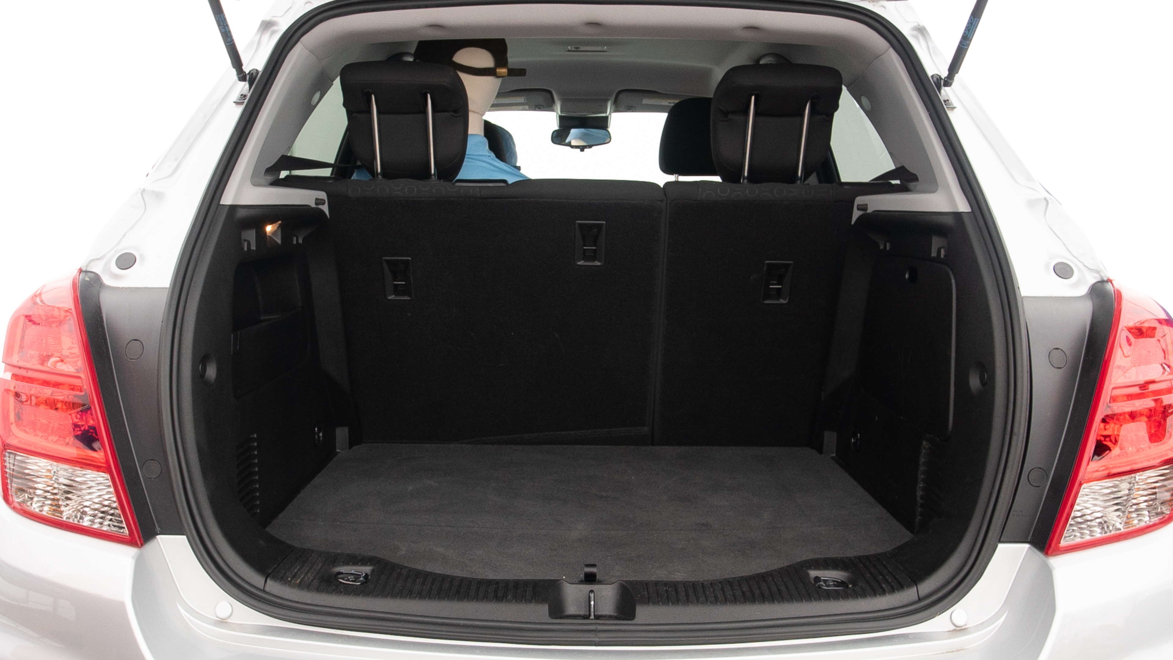 The trunk lid is open showing full view of the trunk. A baby stroller, three grocery carriers and a set of golf clubs are placed inside.