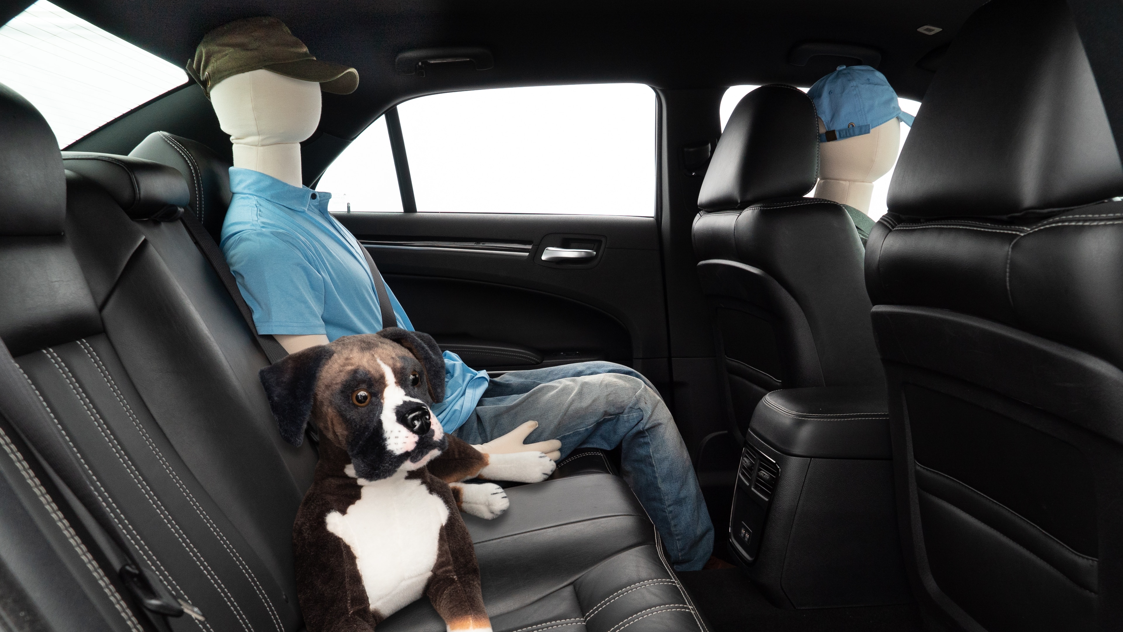 A series of second-row backseat photos is shown including one seating a baby seat and one seating a 6'1" mannequin.