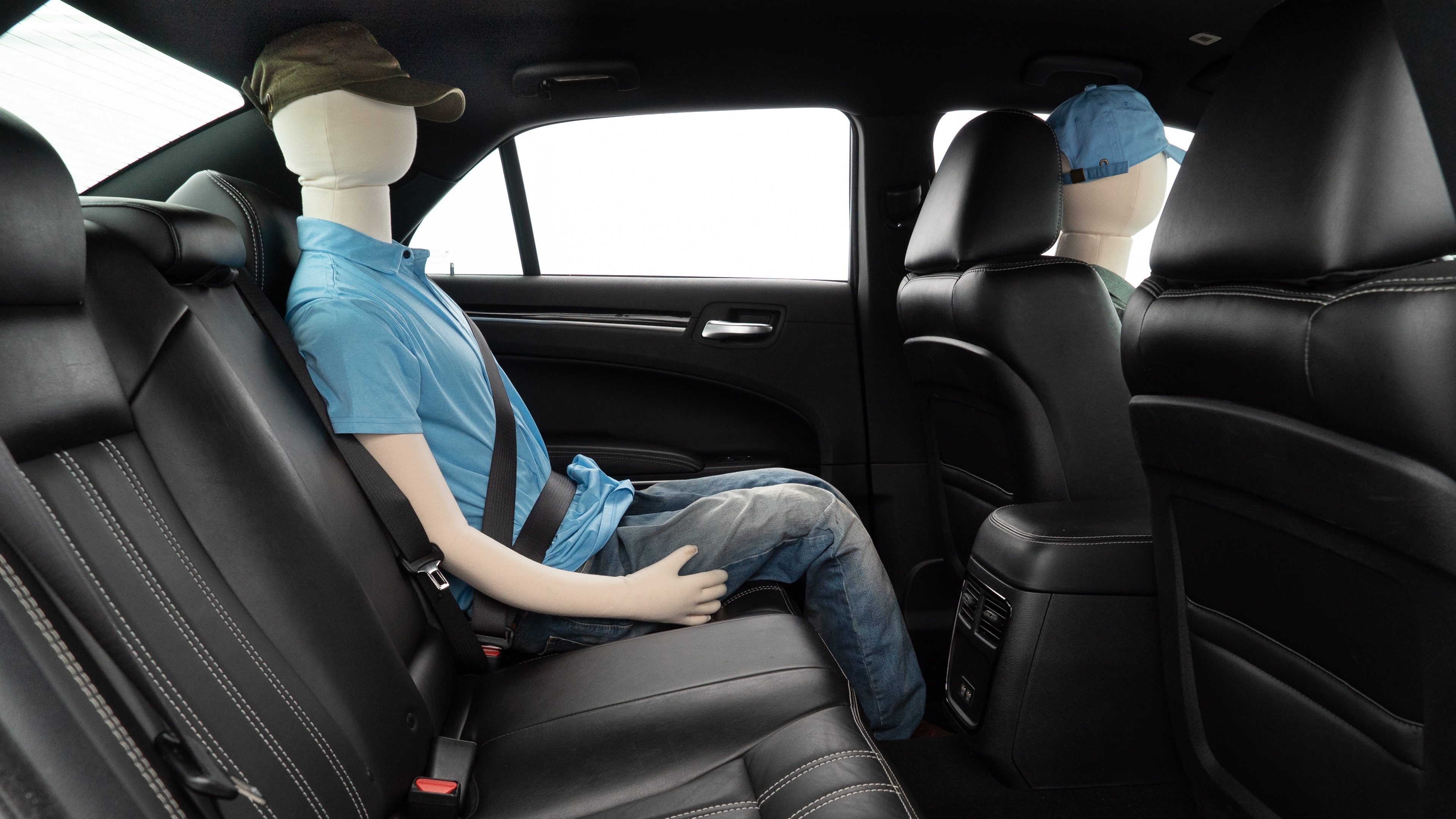A series of second-row backseat photos is shown including one seating a baby seat and one seating a 6'1" mannequin.