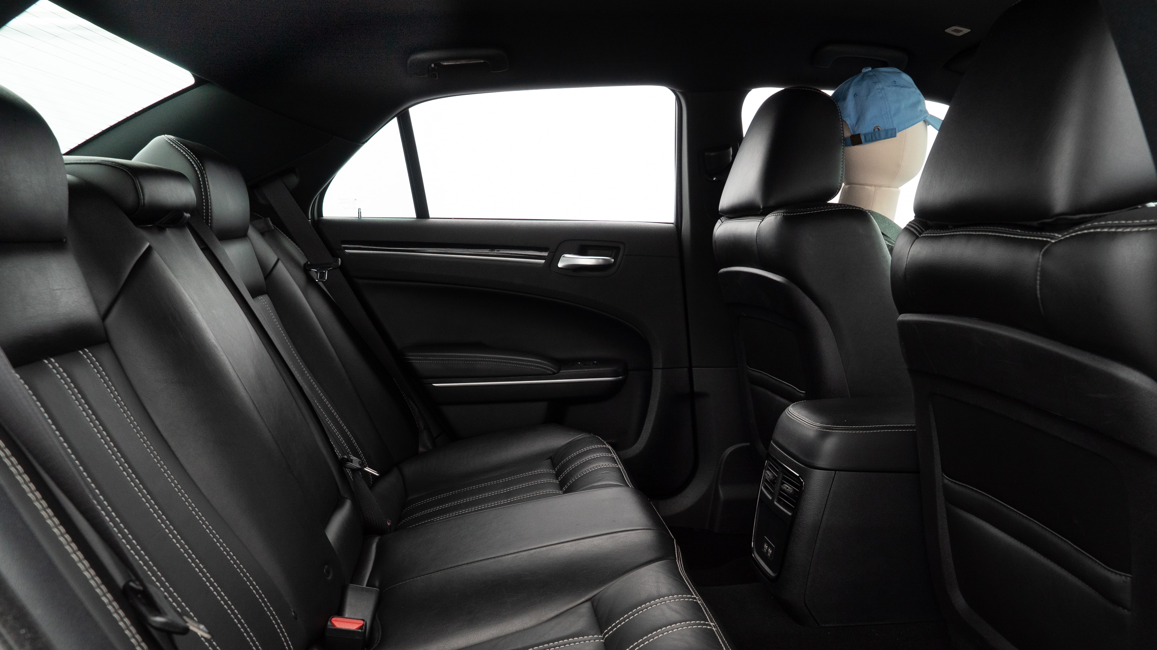 A series of second-row backseat photos is shown including one seating a baby seat and one seating a 6'1" mannequin.