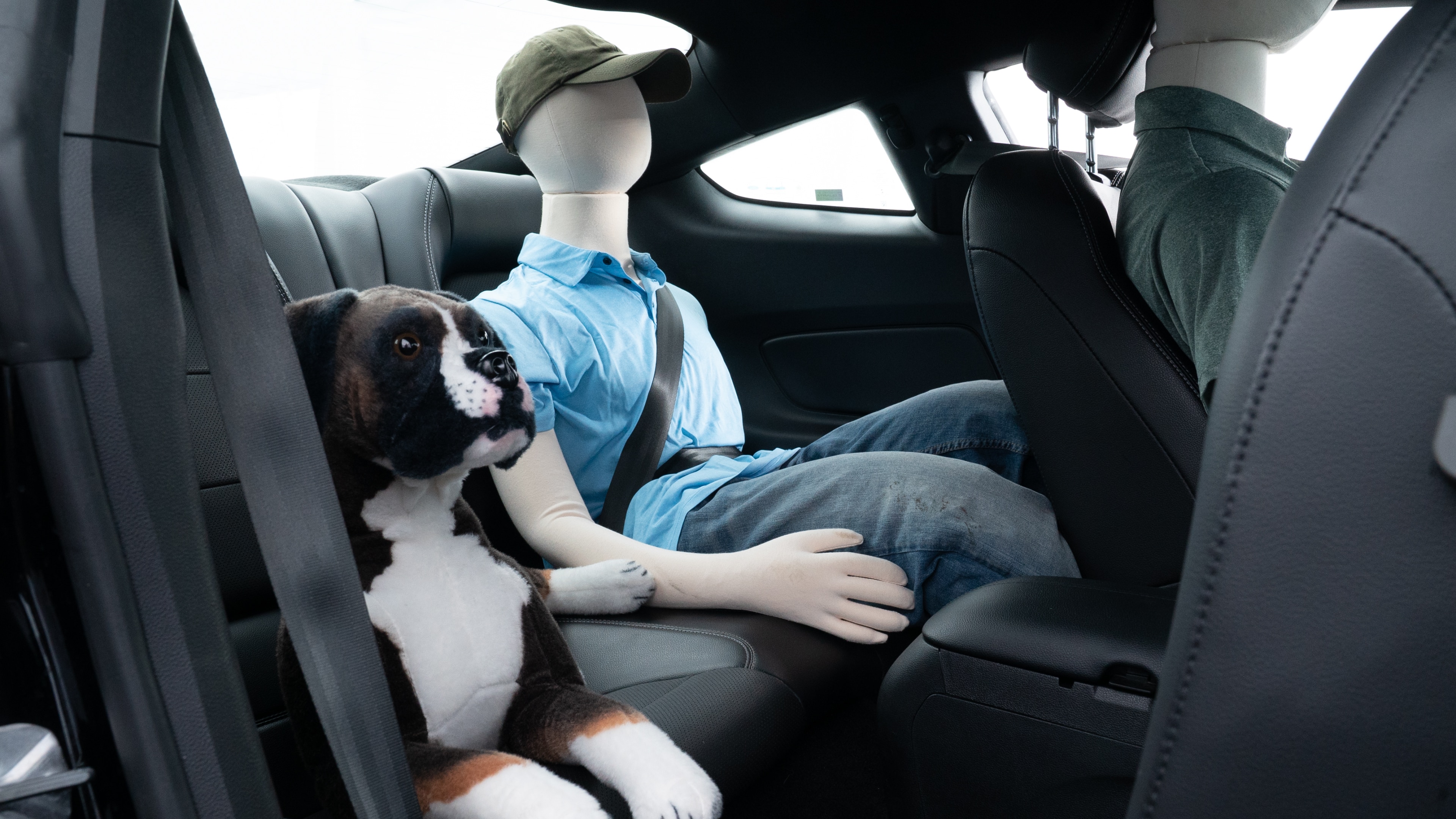 A series of second-row backseat photos is shown including one seating a baby seat and one seating a 6'1" mannequin.