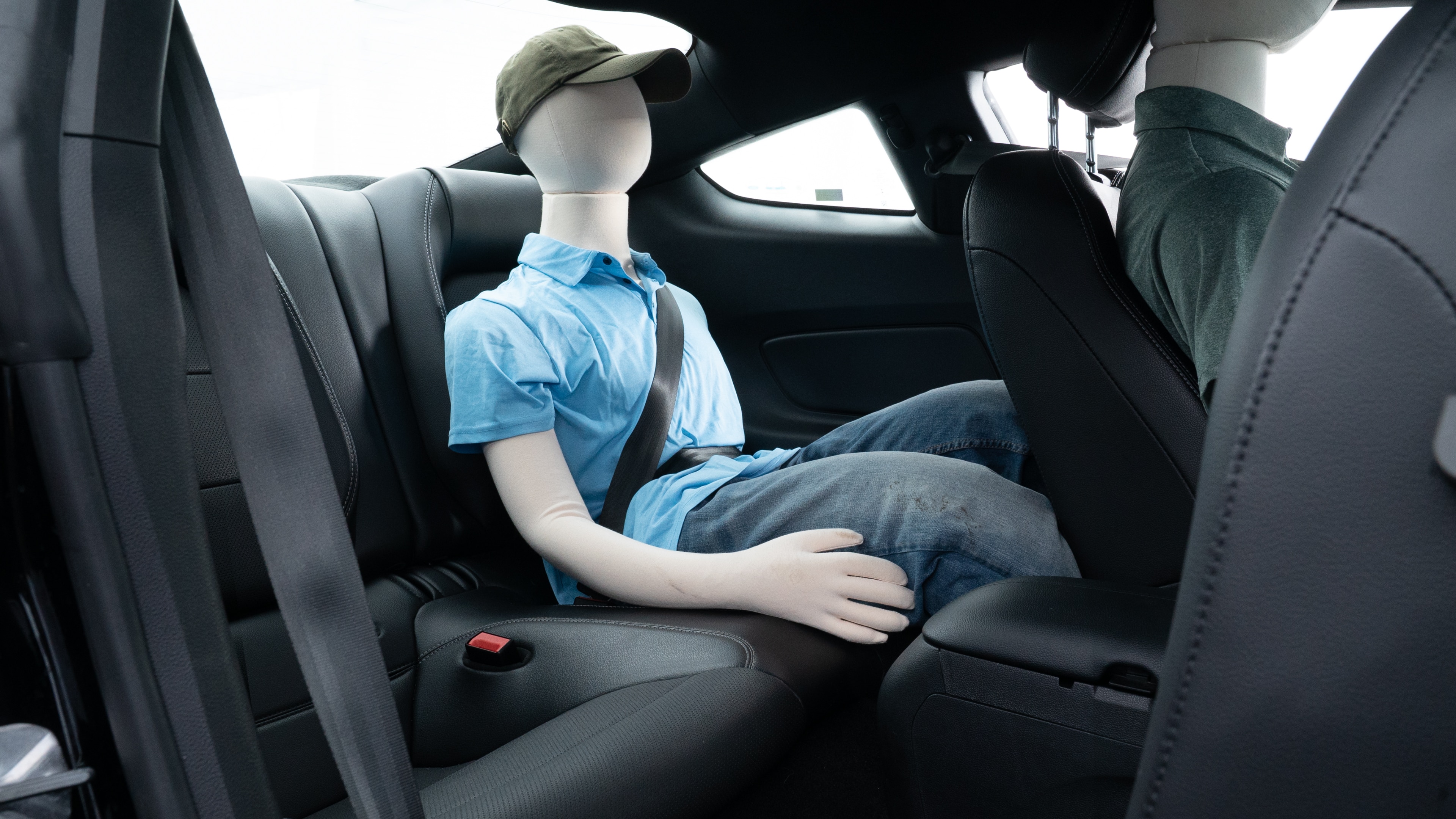 A series of second-row backseat photos is shown including one seating a baby seat and one seating a 6'1" mannequin.