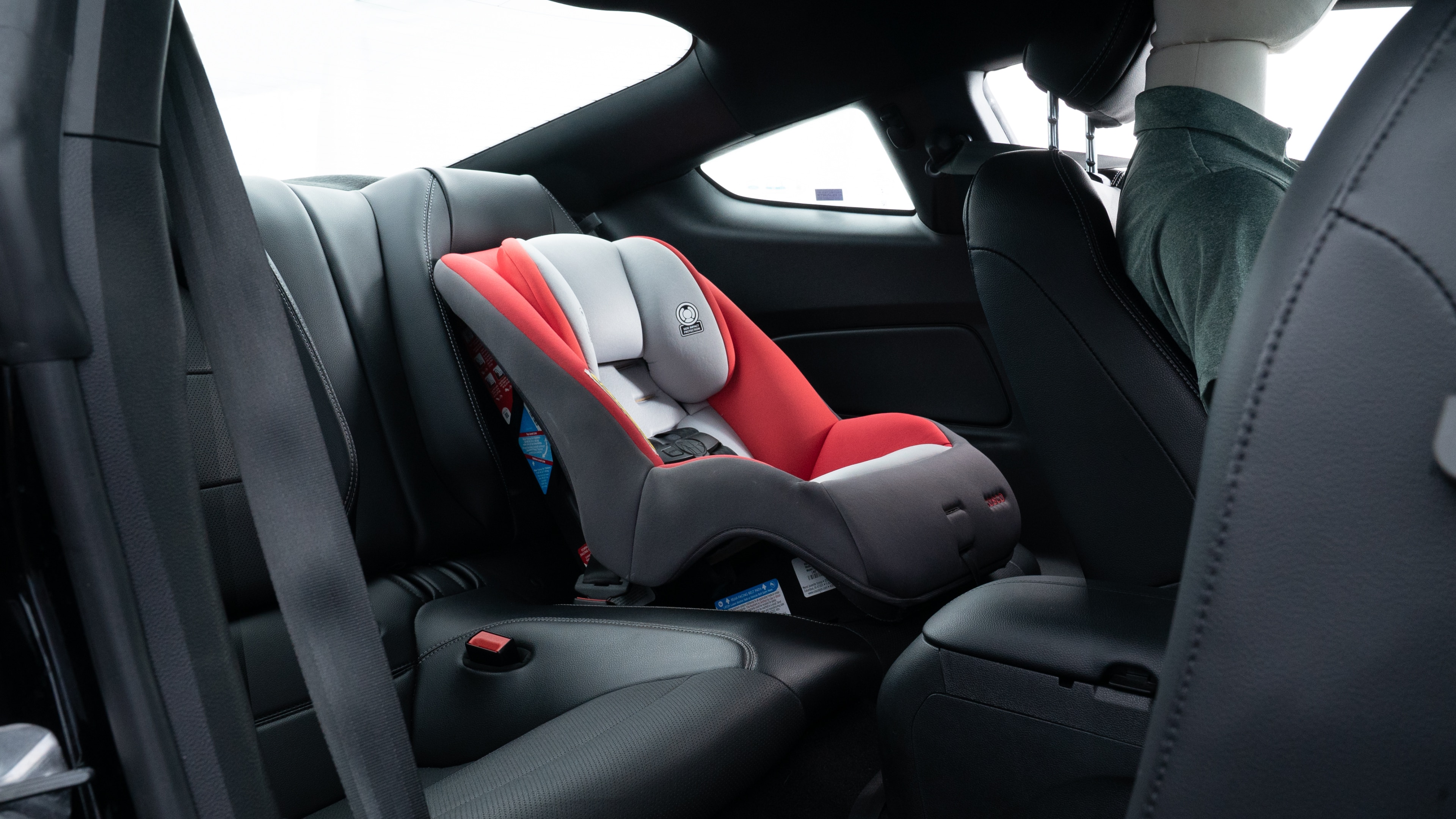 A series of second-row backseat photos is shown including one seating a baby seat and one seating a 6'1" mannequin.