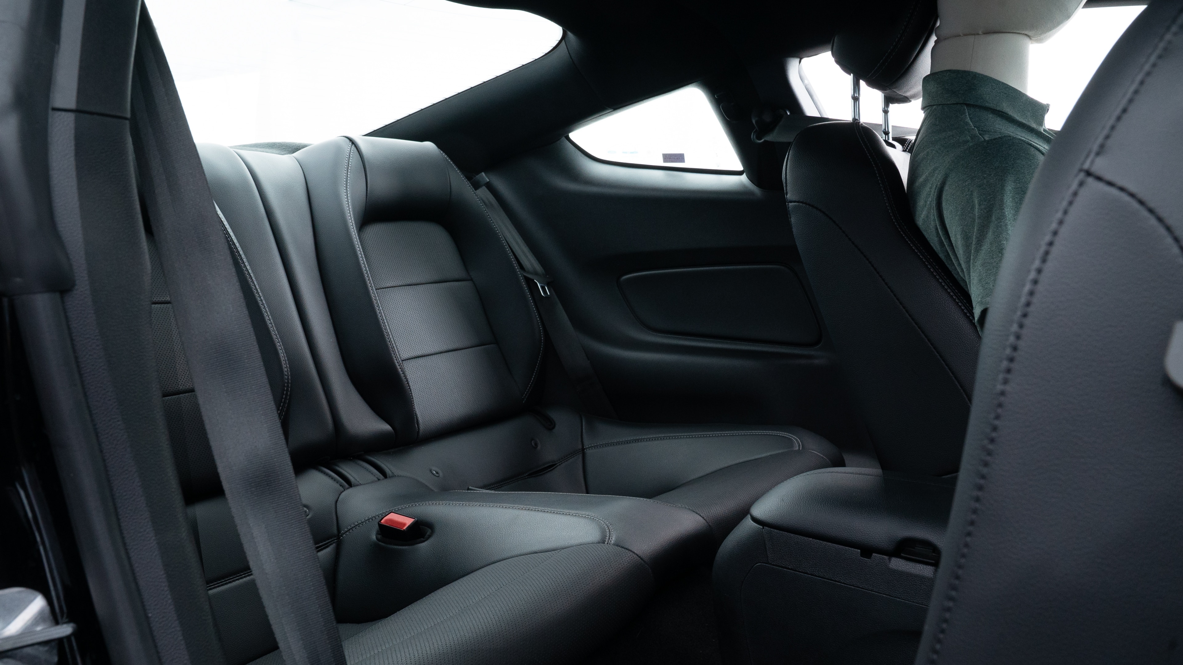 A series of second-row backseat photos is shown including one seating a baby seat and one seating a 6'1" mannequin.