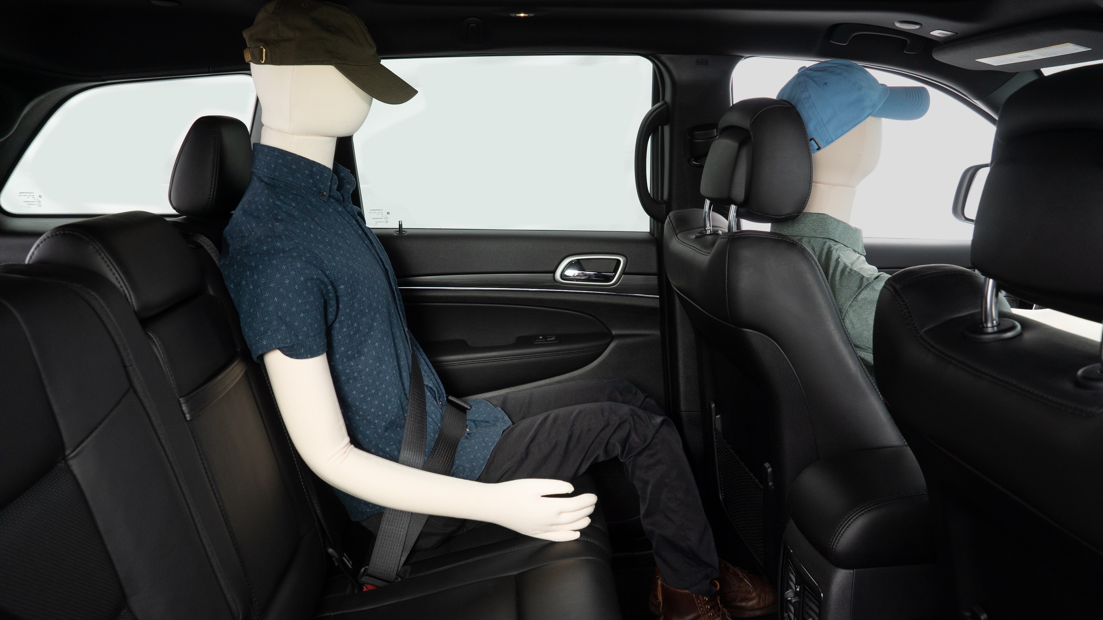 A series of second-row backseat photos is shown including one seating a baby seat and one seating a 6'1" mannequin.