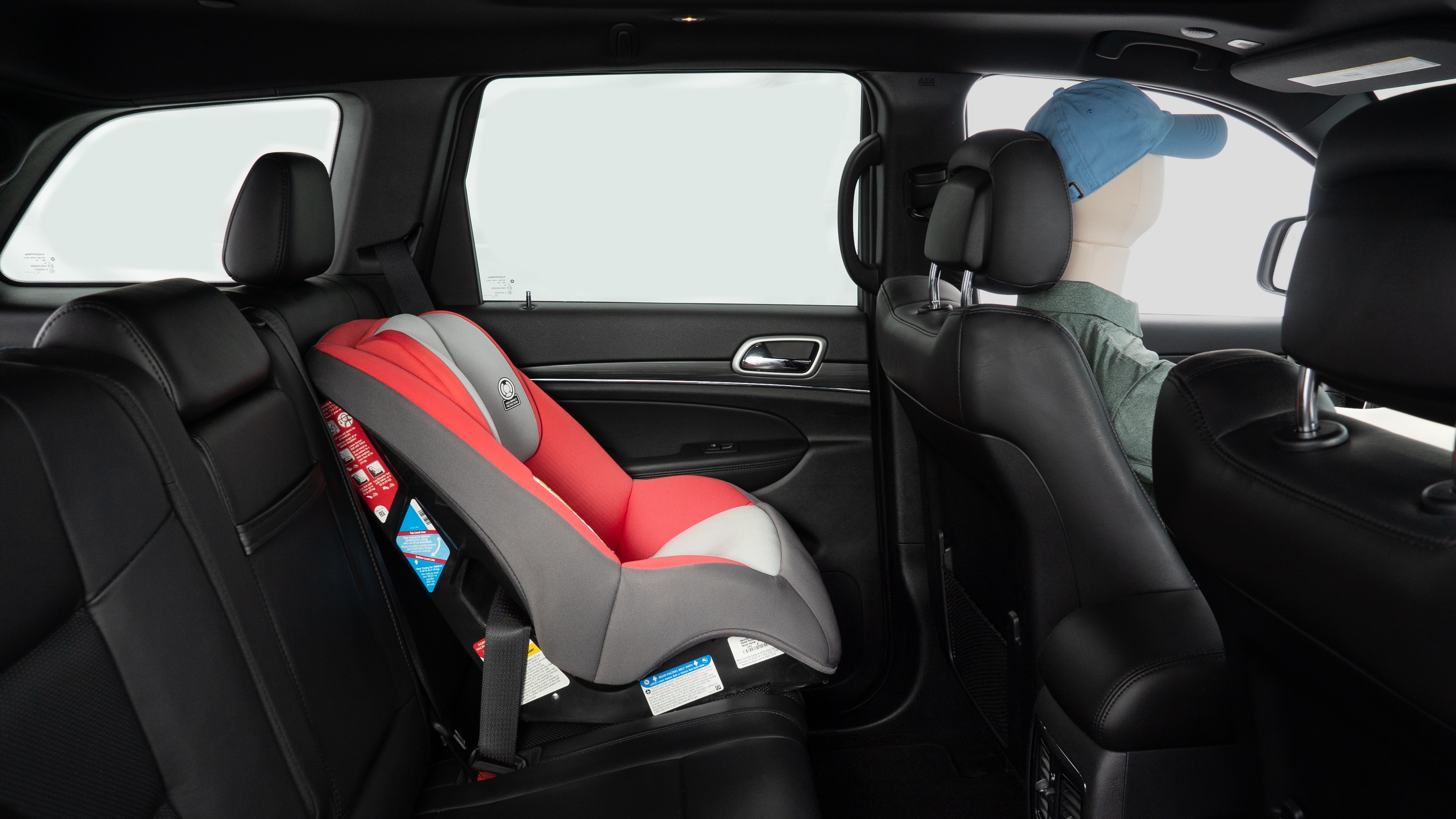 A series of second-row backseat photos is shown including one seating a baby seat and one seating a 6'1" mannequin.