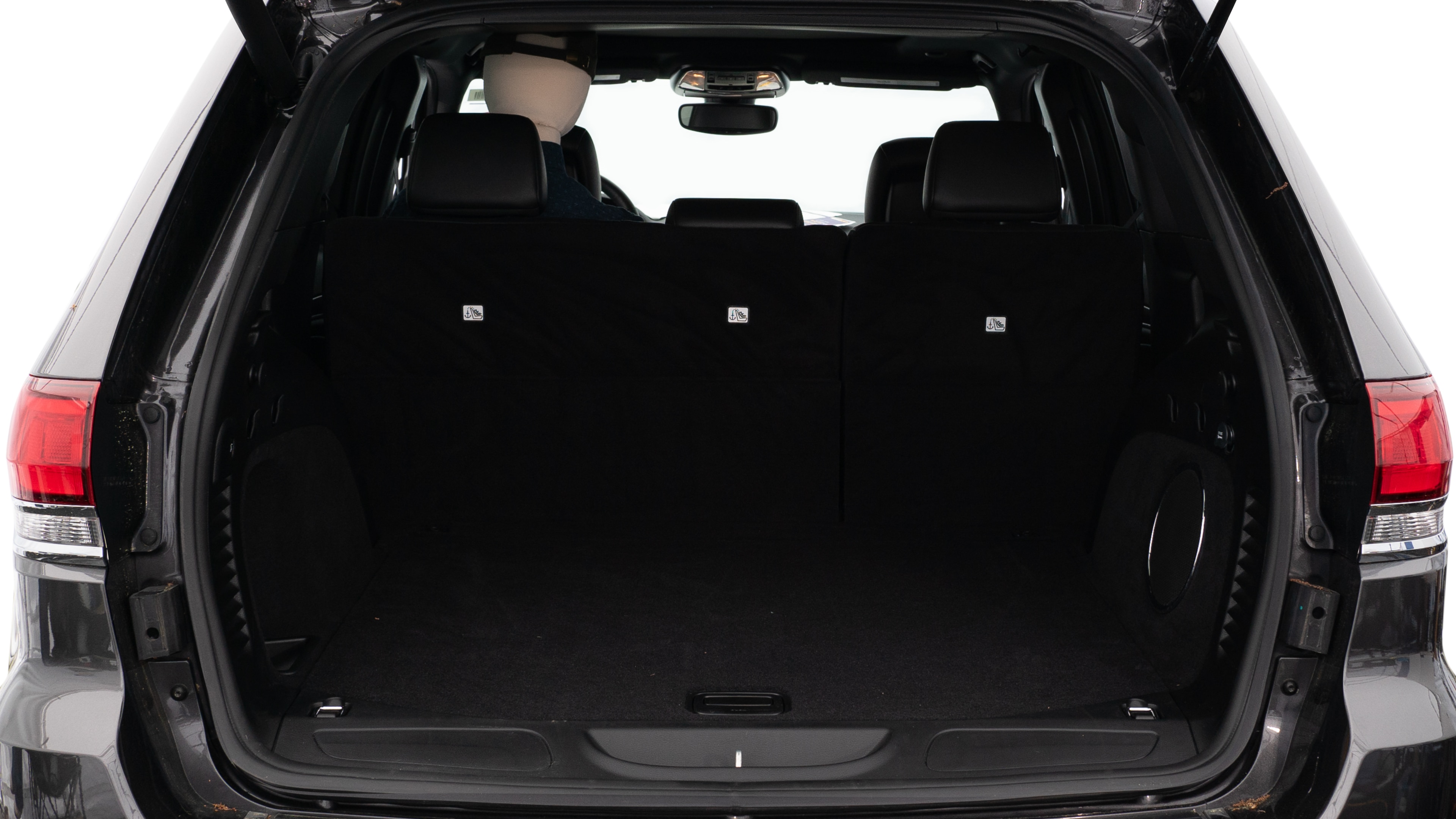 The trunk lid is open showing full view of the trunk. A baby stroller, three grocery carriers, two camping chairs in the carrying bag, and a set of golf clubs are placed inside.