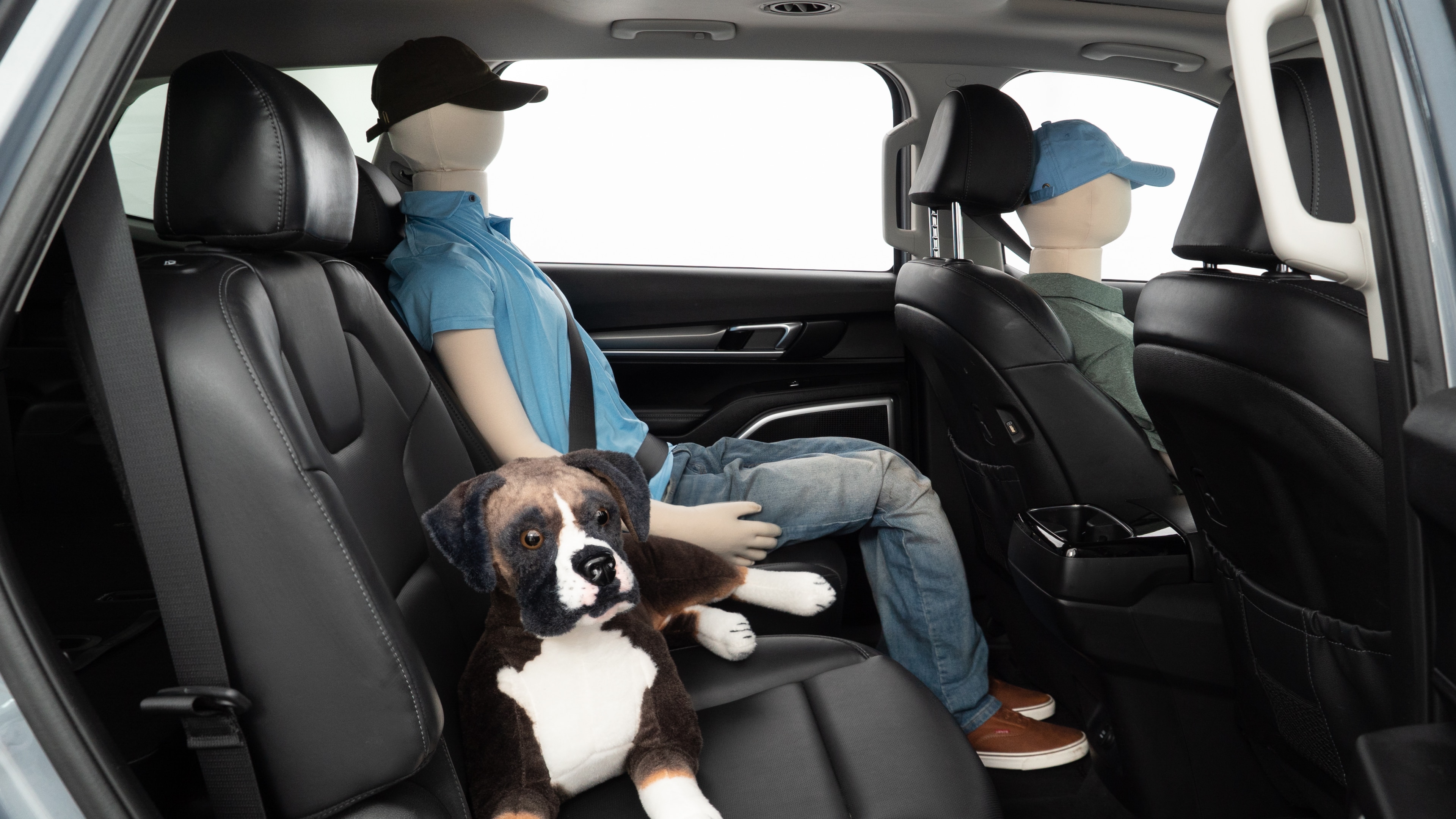 A series of second-row backseat photos is shown including one seating a baby seat and one seating a 6'1" mannequin.