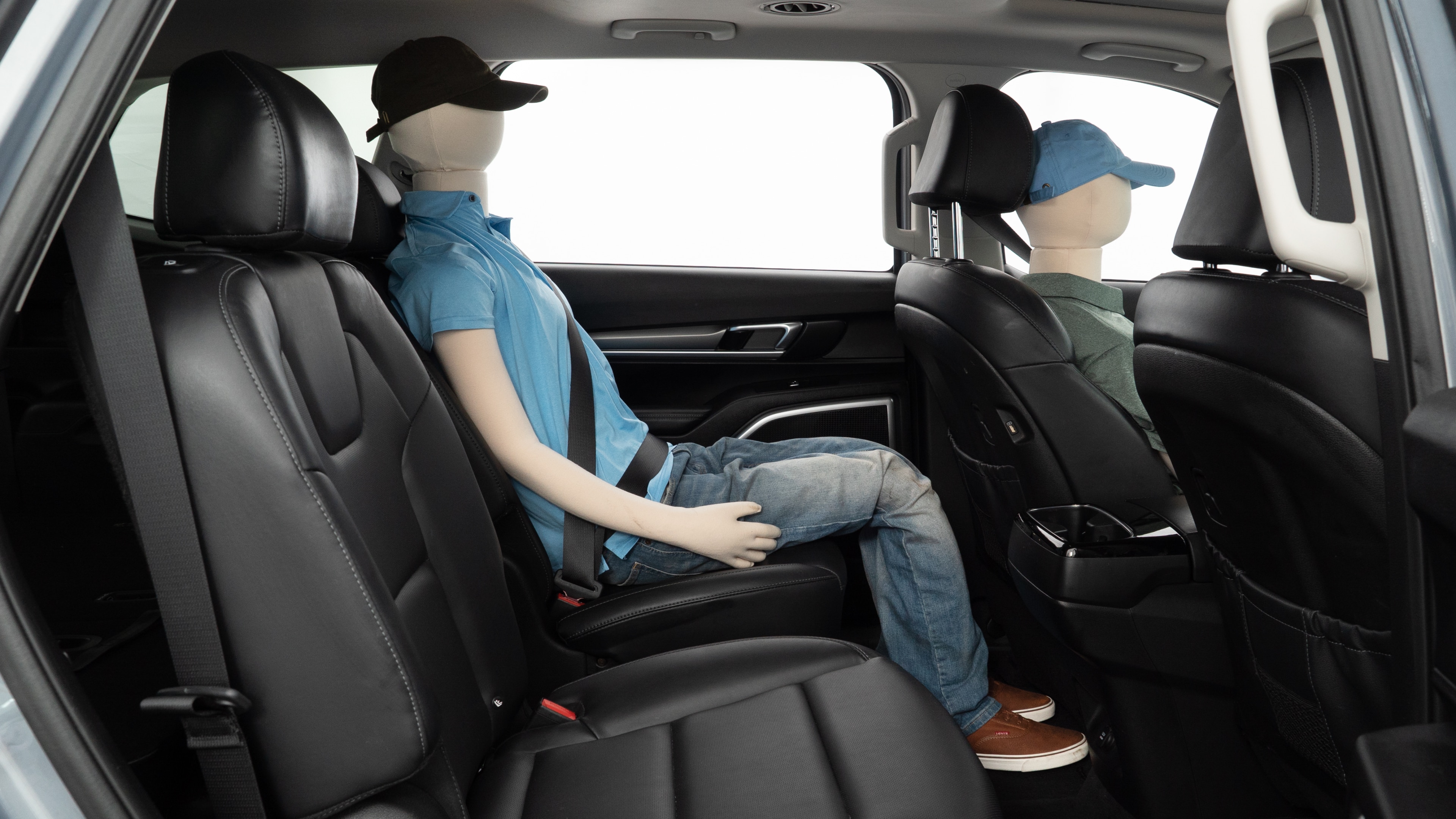 A series of second-row backseat photos is shown including one seating a baby seat and one seating a 6'1" mannequin.