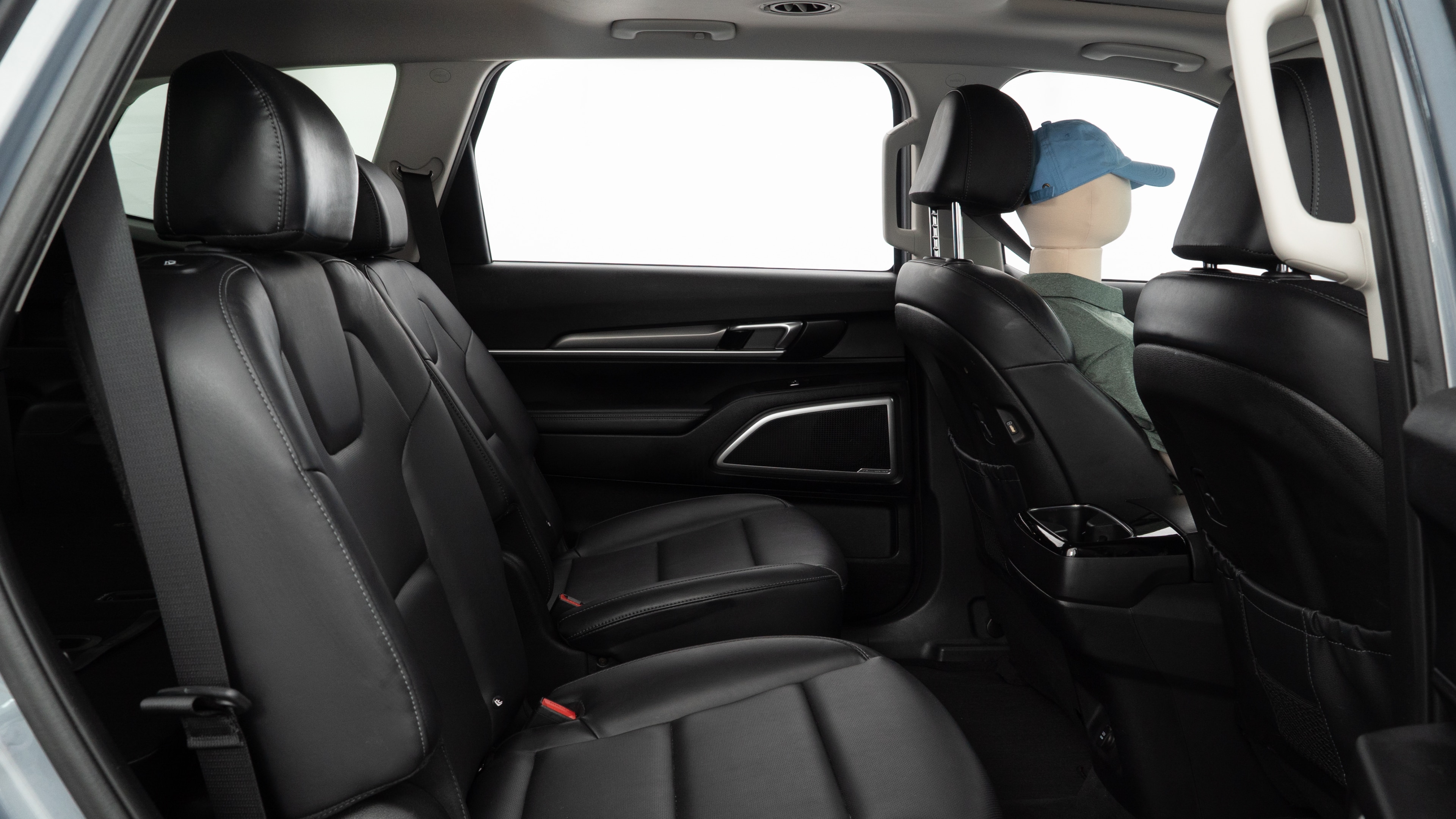 A series of second-row backseat photos is shown including one seating a baby seat and one seating a 6'1" mannequin.
