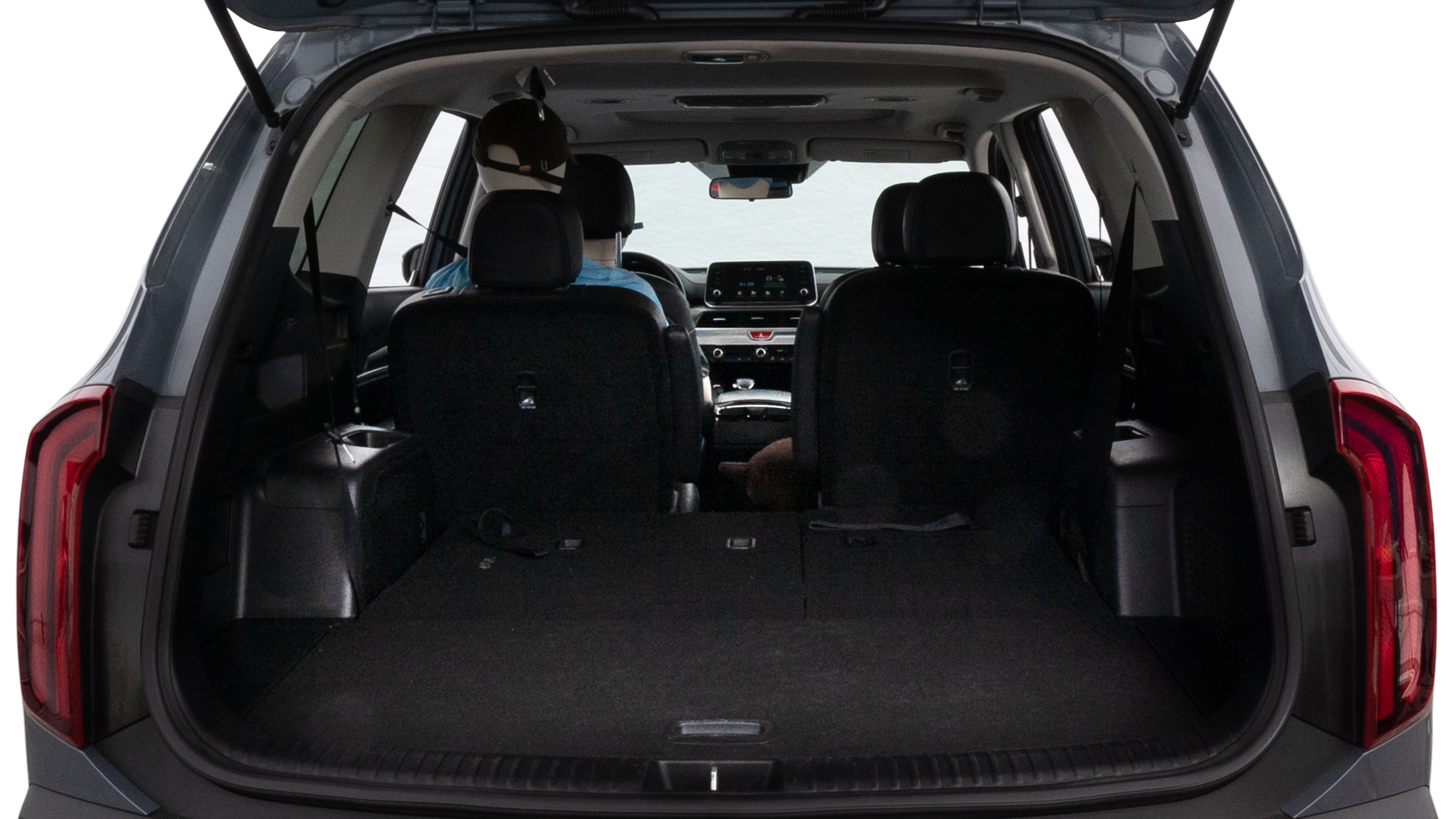 The trunk lid is open showing full view of the trunk. A baby stroller, three grocery carriers, two camping chairs in the carrying bag, and a set of golf clubs are placed inside.