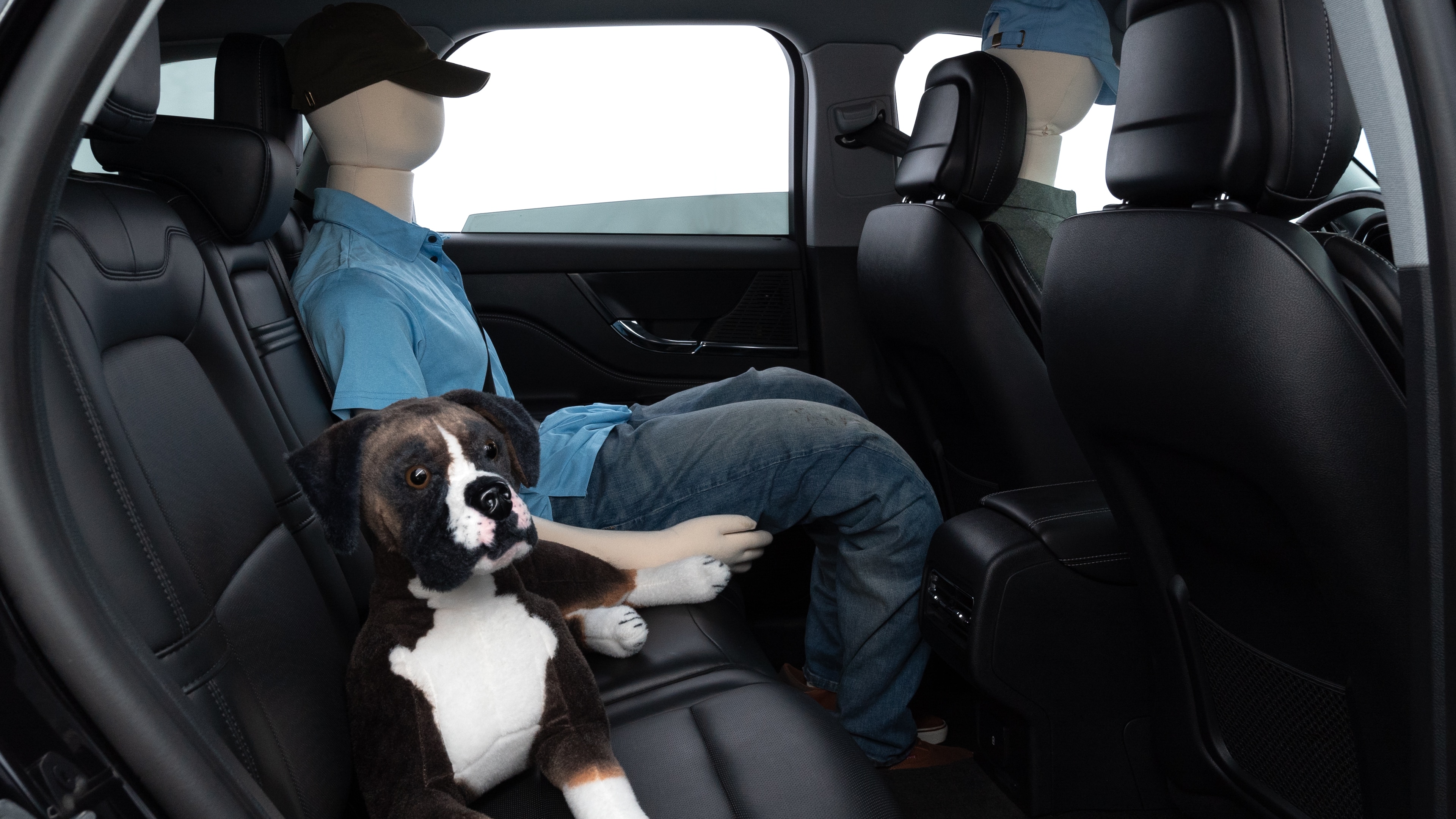 A series of second-row backseat photos is shown including one seating a baby seat and one seating a 6'1" mannequin.