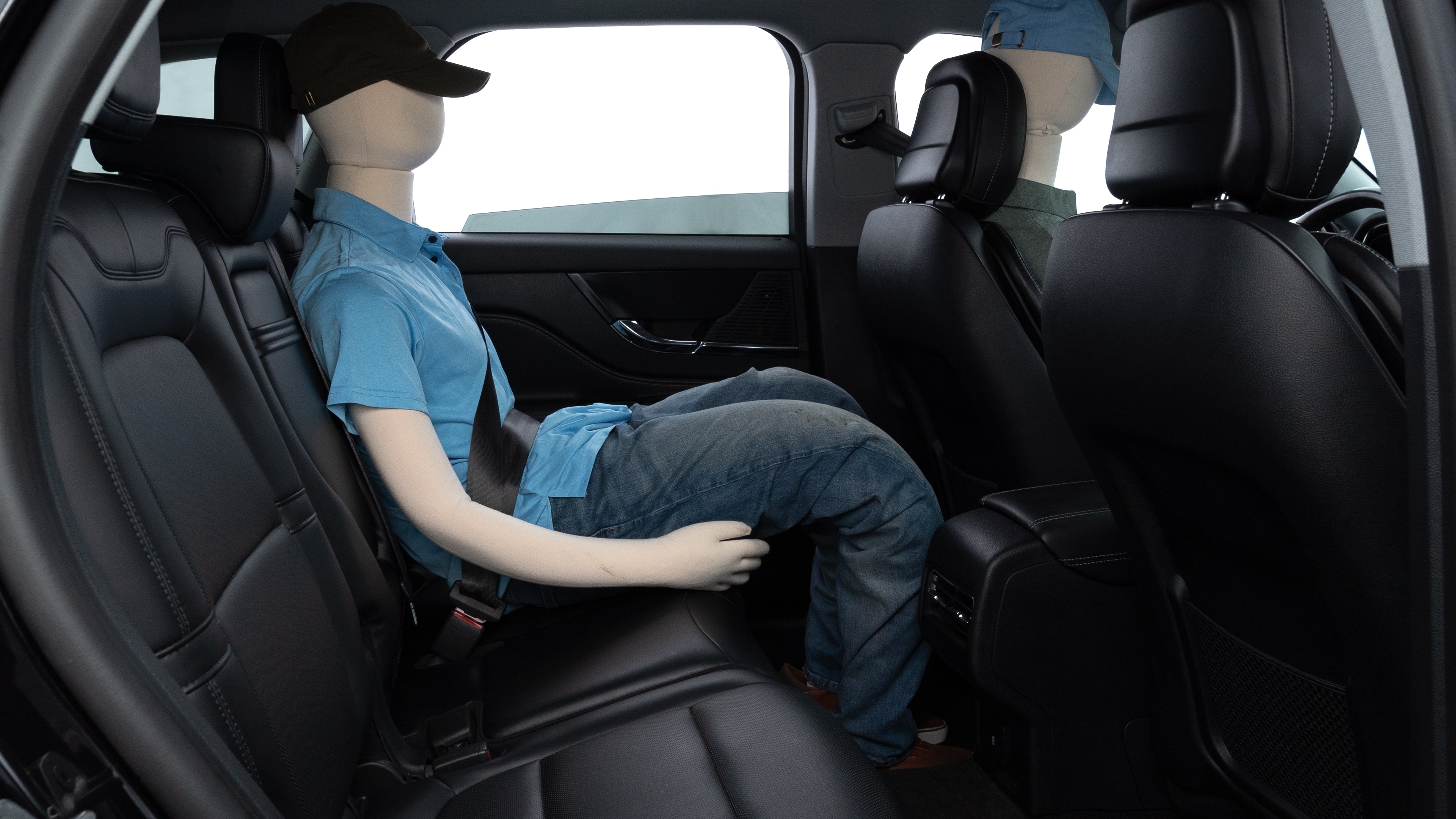 A series of second-row backseat photos is shown including one seating a baby seat and one seating a 6'1" mannequin.