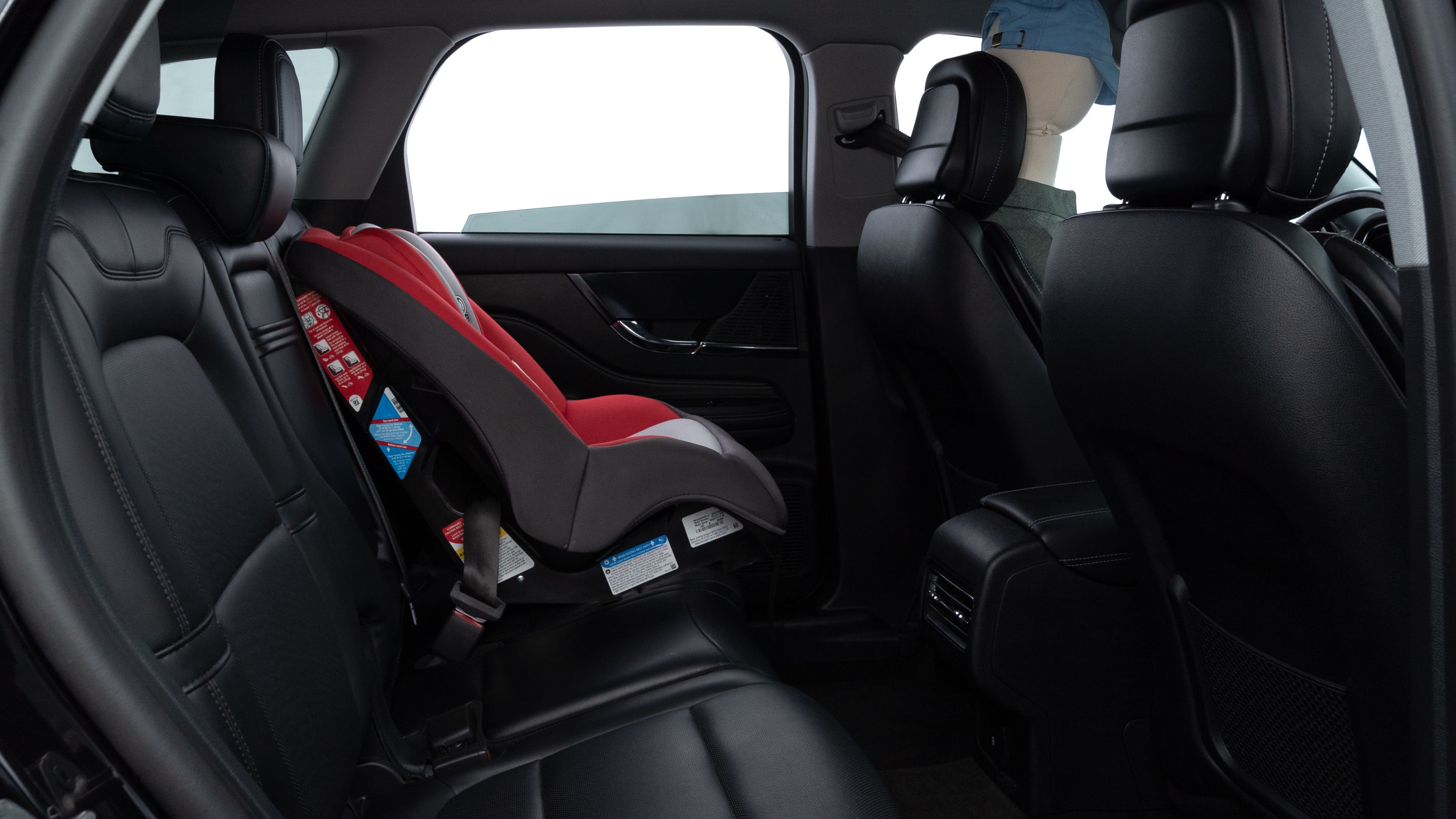 A series of second-row backseat photos is shown including one seating a baby seat and one seating a 6'1" mannequin.