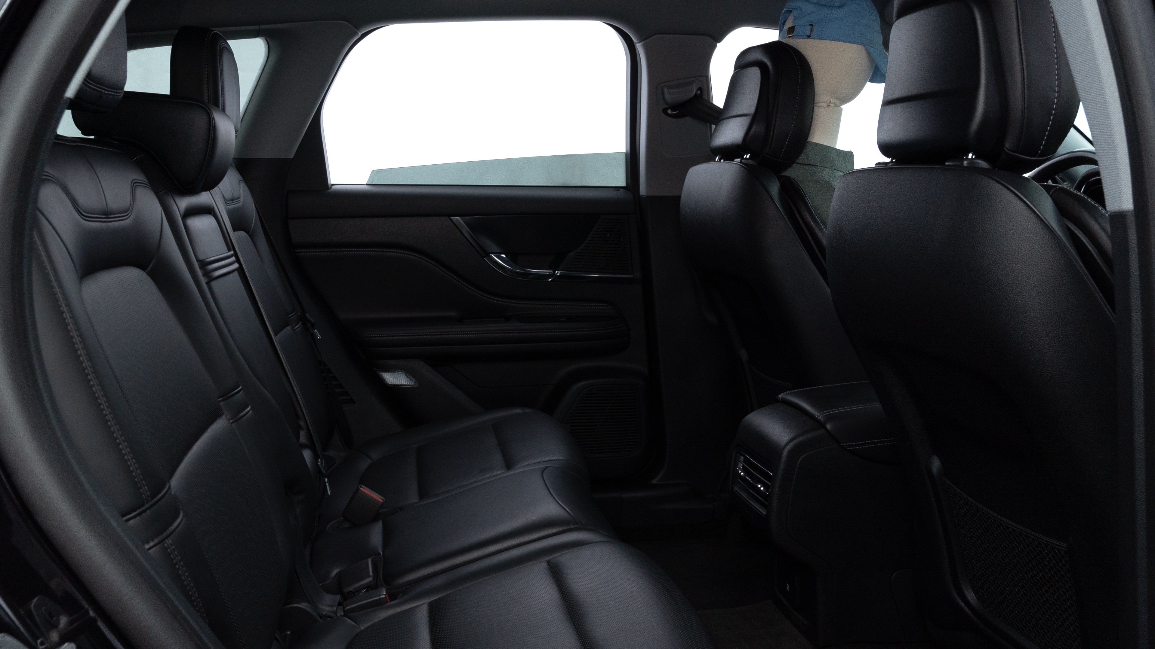 A series of second-row backseat photos is shown including one seating a baby seat and one seating a 6'1" mannequin.