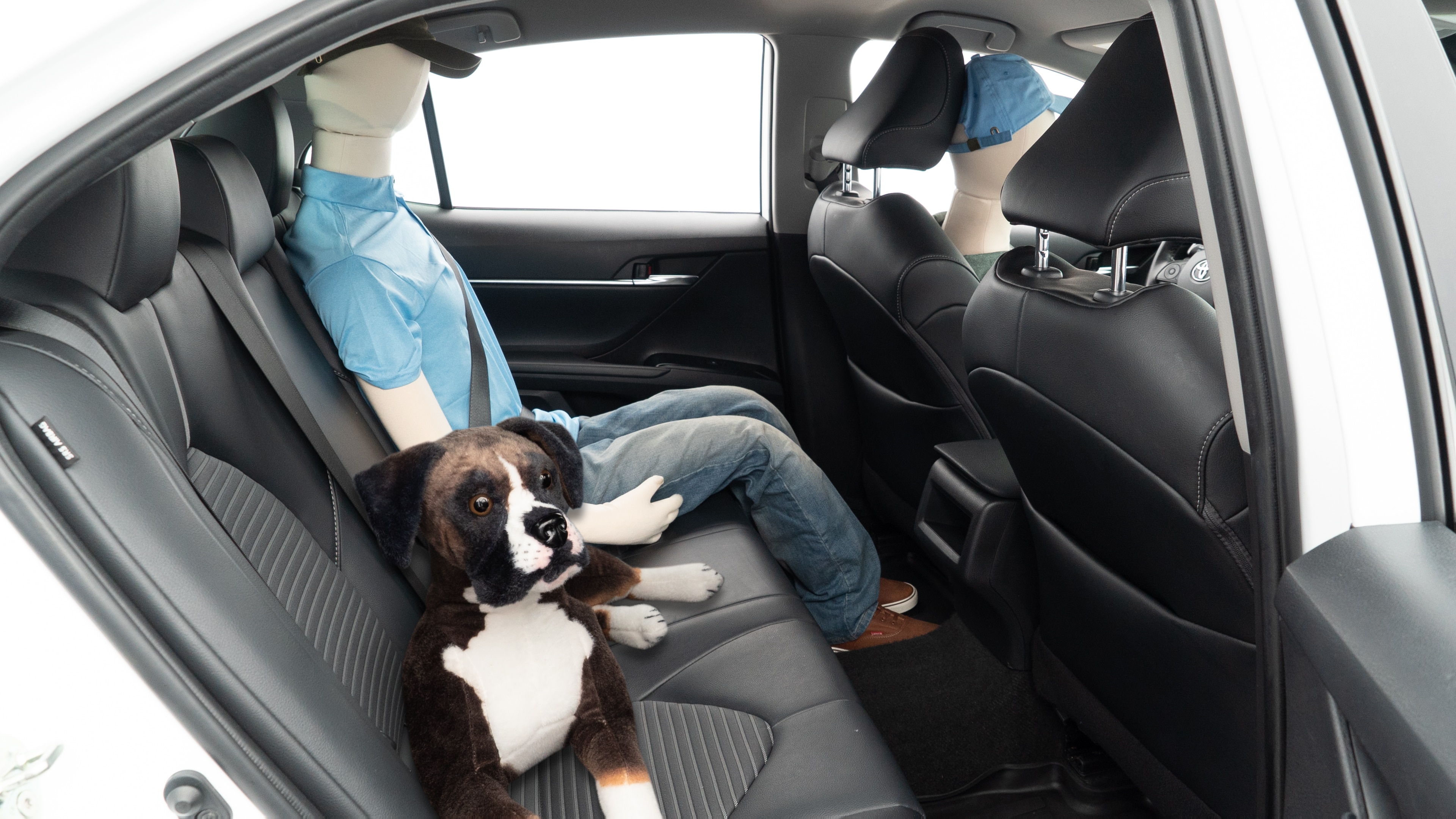 A series of second-row backseat photos is shown including one seating a baby seat and one seating a 6'1" mannequin.