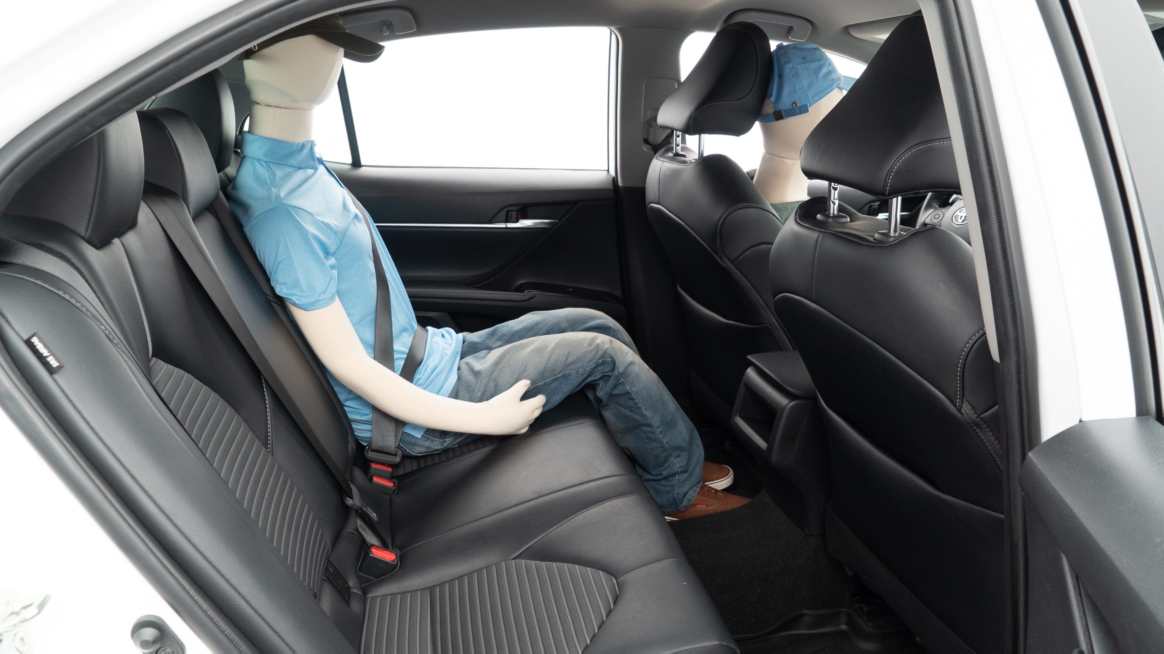 A series of second-row backseat photos is shown including one seating a baby seat and one seating a 6'1" mannequin.