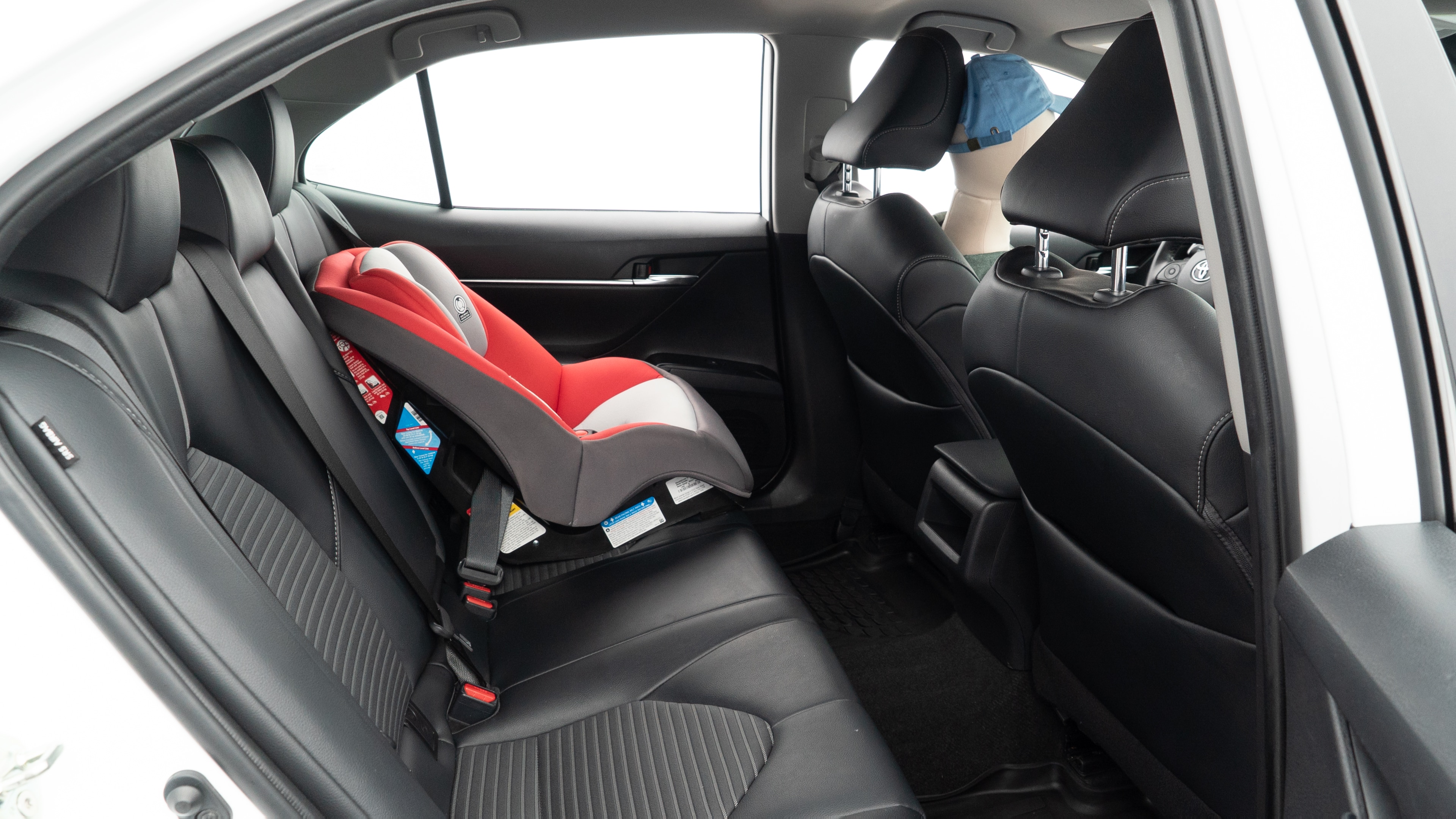 A series of second-row backseat photos is shown including one seating a baby seat and one seating a 6'1" mannequin.