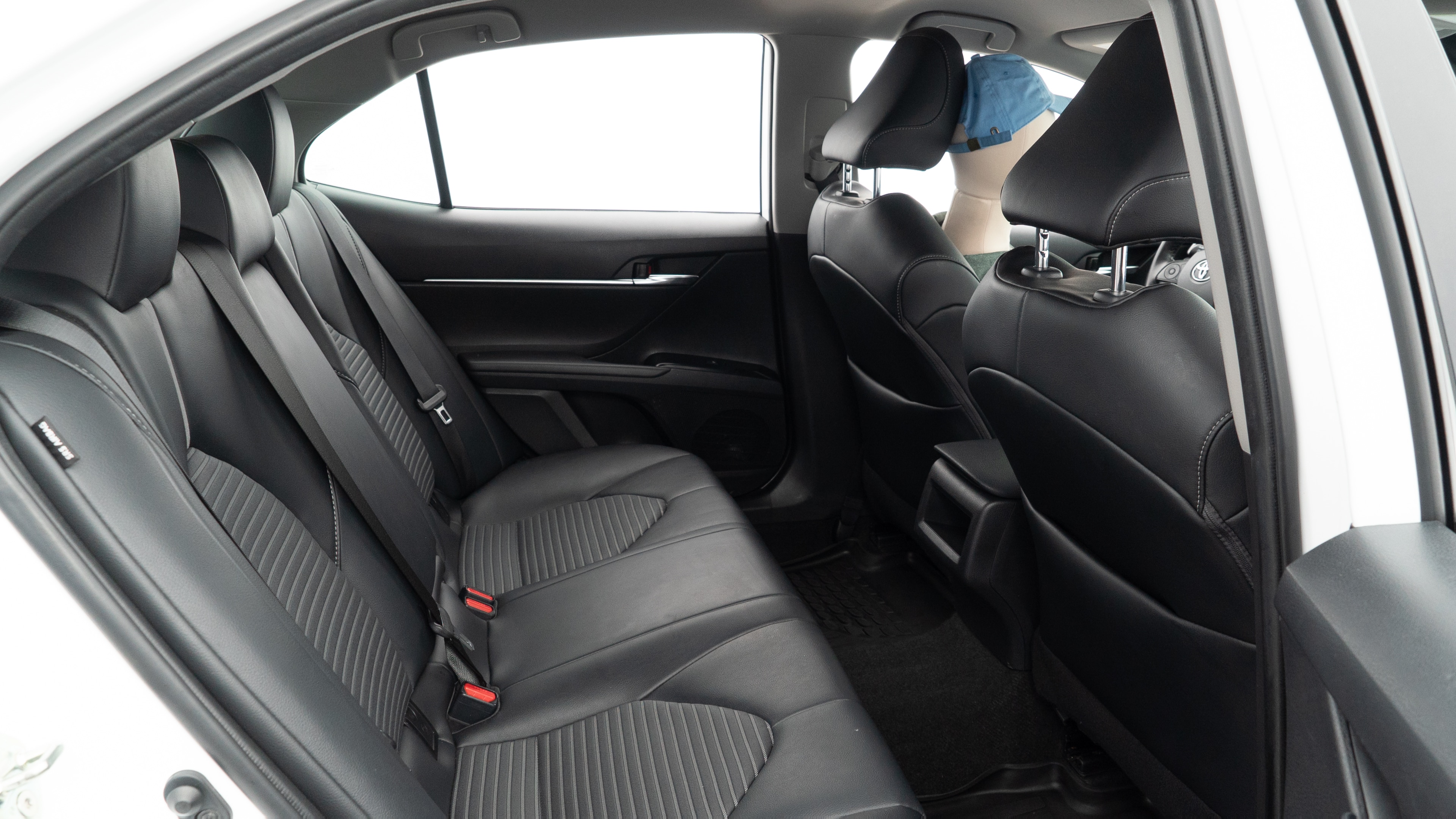 A series of second-row backseat photos is shown including one seating a baby seat and one seating a 6'1" mannequin.
