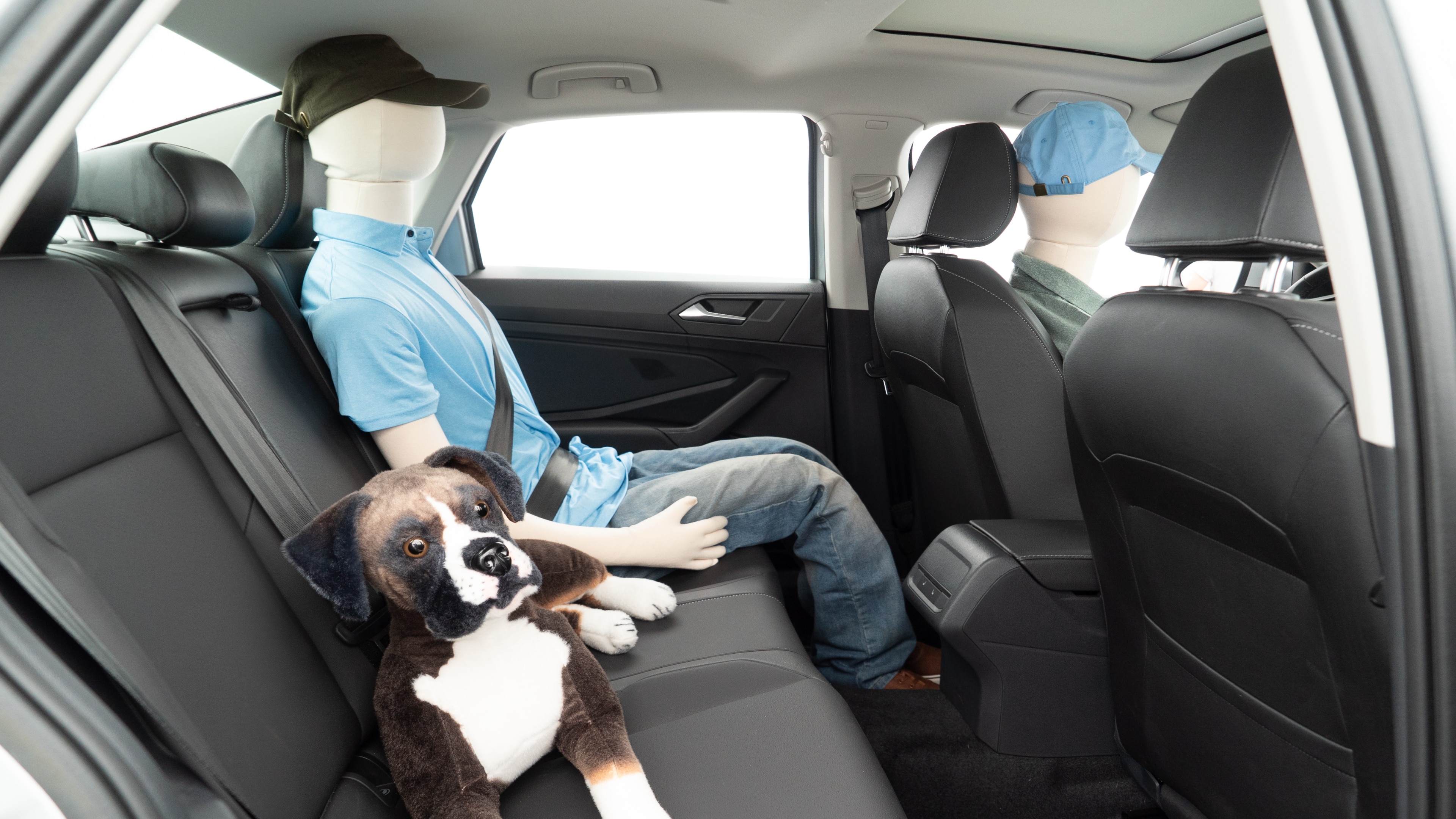 A series of second-row backseat photos is shown including one seating a baby seat and one seating a 6'1" mannequin.