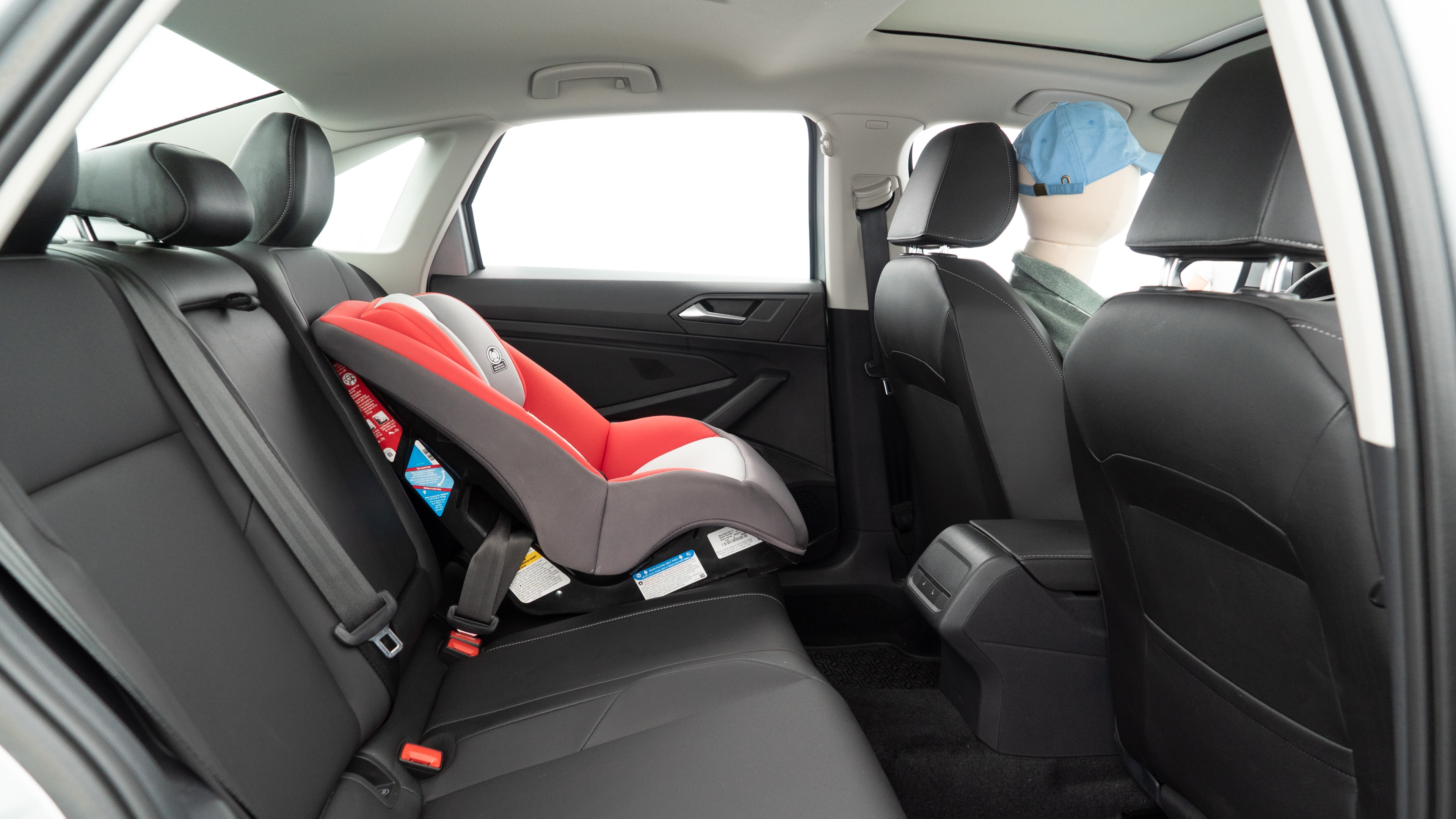 A series of second-row backseat photos is shown including one seating a baby seat and one seating a 6'1" mannequin.