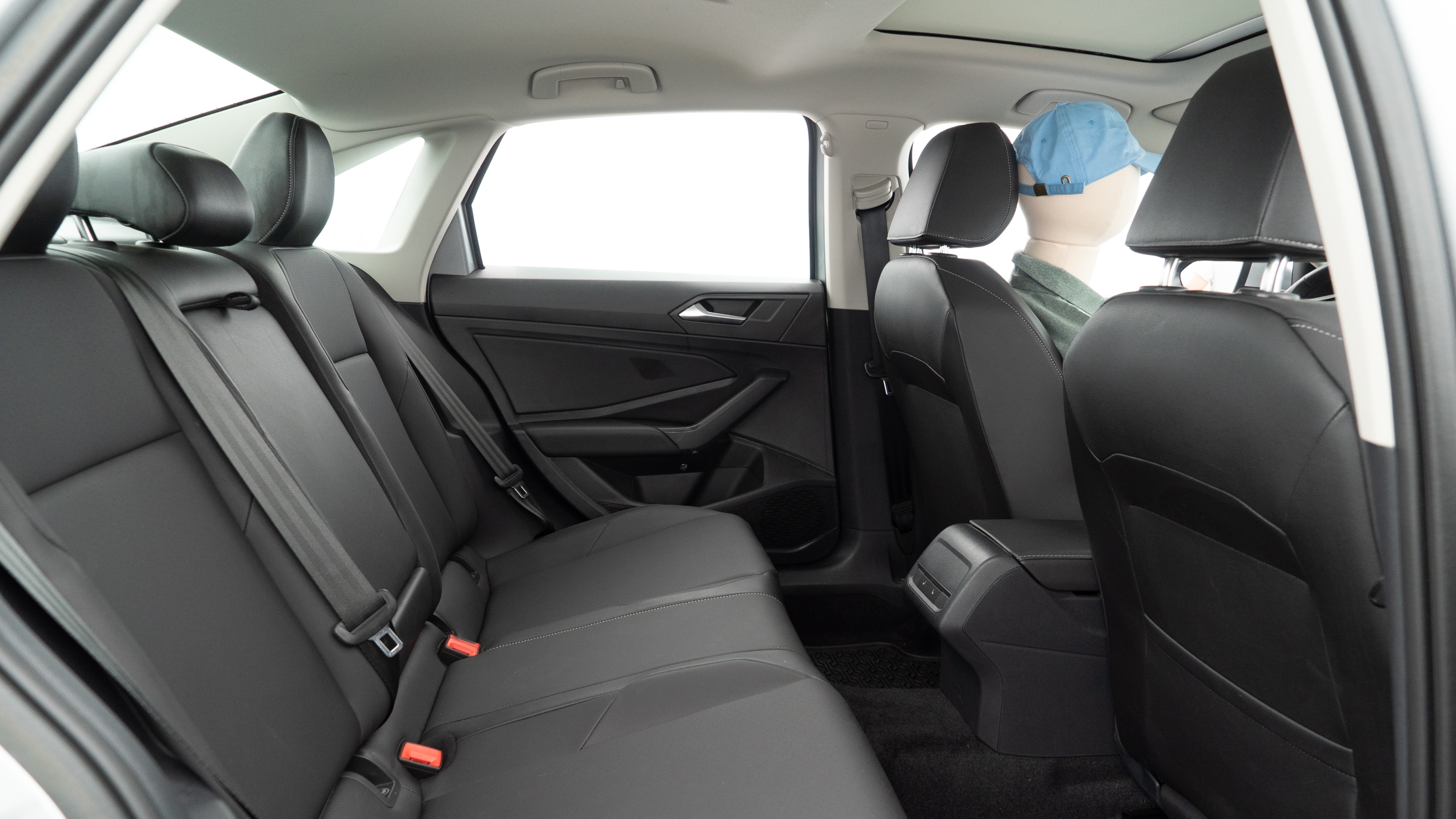 A series of second-row backseat photos is shown including one seating a baby seat and one seating a 6'1" mannequin.