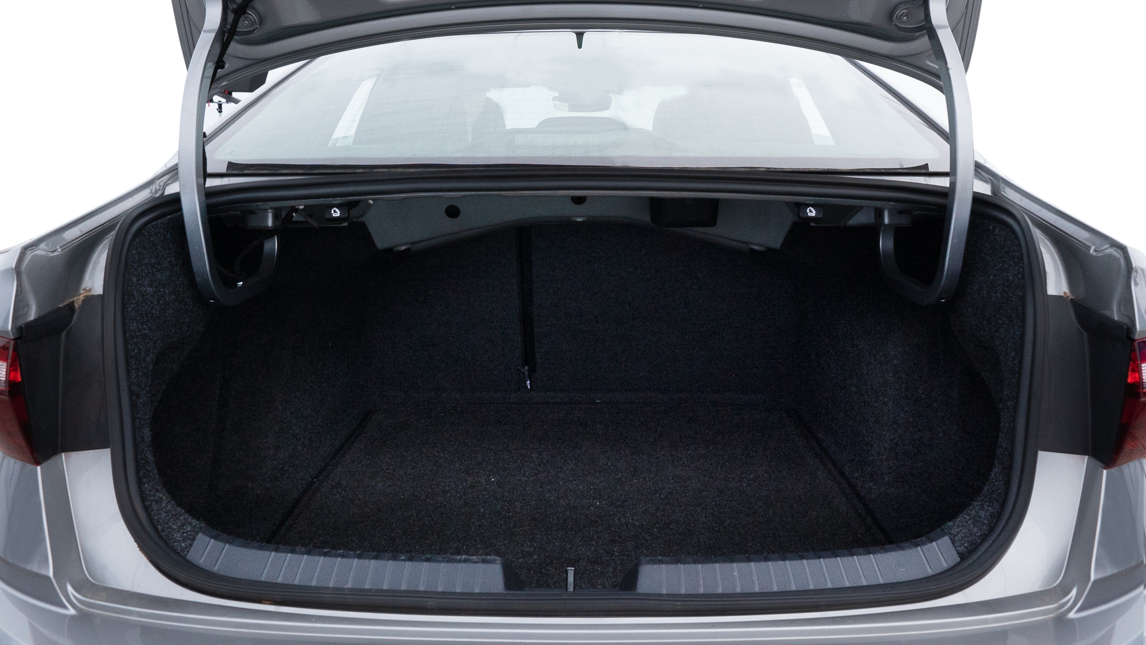 The trunk lid is open showing full view of the trunk. A baby stroller, three grocery carriers, two camping chairs in the carrying bag, and a set of golf clubs are placed inside.