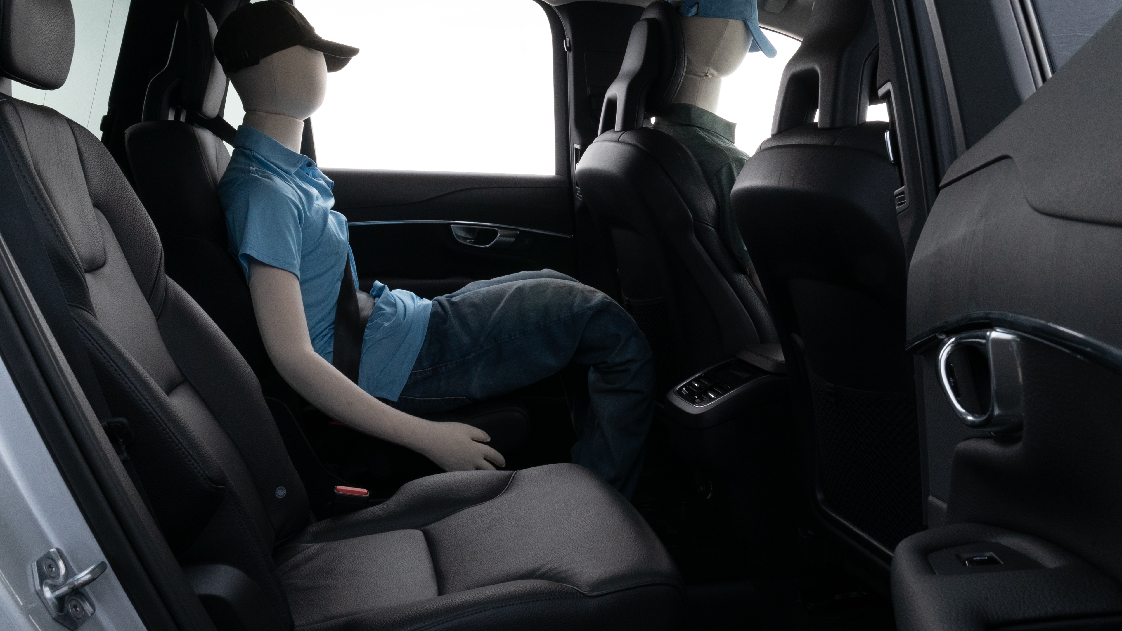 A series of second-row backseat photos is shown including one seating a baby seat and one seating a 6'1" mannequin.