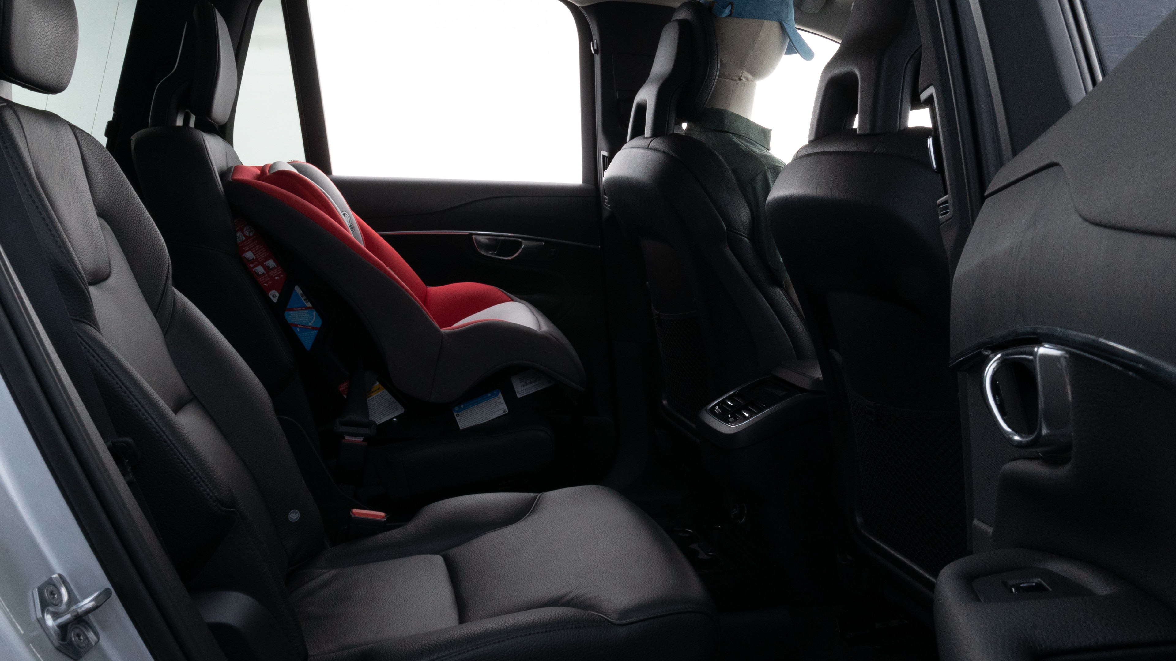 A series of second-row backseat photos is shown including one seating a baby seat and one seating a 6'1" mannequin.
